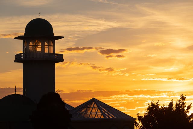 The sun sets over the Central Mosque of Brent, north London. Picture date: Sunday July 10, 2022.