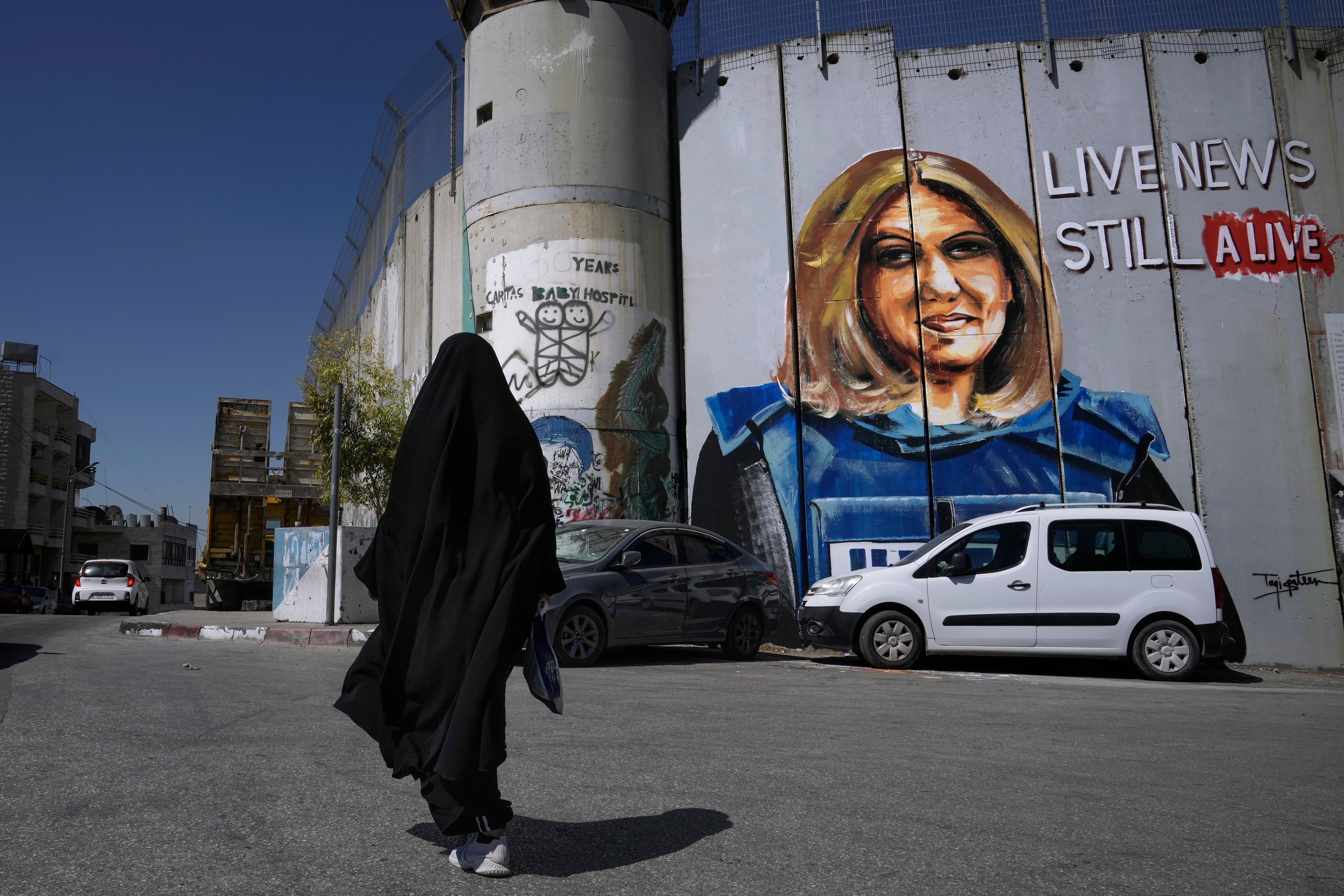 A mural by Palestinian artist Taqi Spateen depicts slain Palestinian-American journalist Shireen Abu Akleh