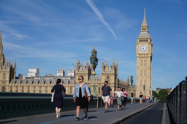 People walk across Westminster Bridge in London amid the heatwave on July 15 (Dominic Lipinski/ PA)