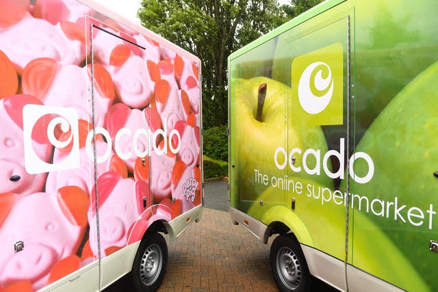 <p>A fleet of Ocado delivery vans</p>