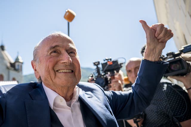 <p>Sepp Blatter celebrates his acquittal outside court in Bellinzona</p>