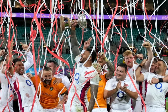 England captain Courtney Lawes, centre, holds up the Ella-Mobbs Cup (Rick Rycroft/AP)
