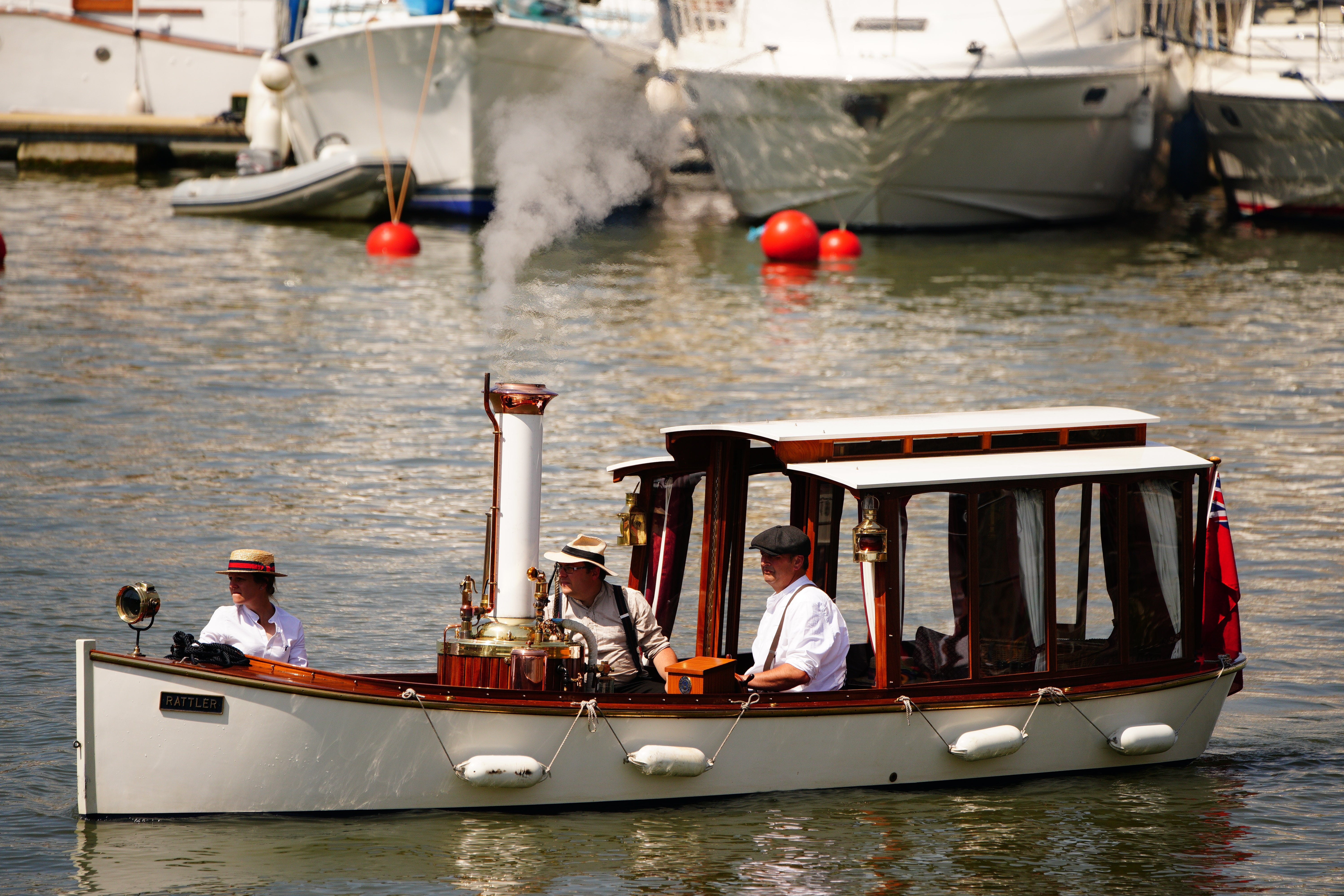Three men take charge of a steam-powered boat as part of the Bristol Harbour Festival (Ben Birchall/PA)