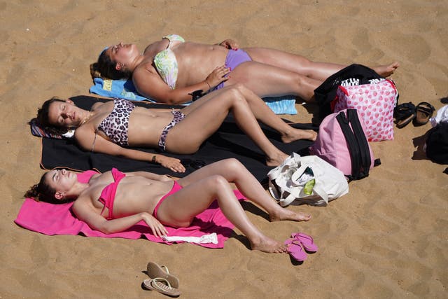 Sunbathers enjoy the hot weather at the beach in Broadstairs, Kent (Gareth Fuller/PA)