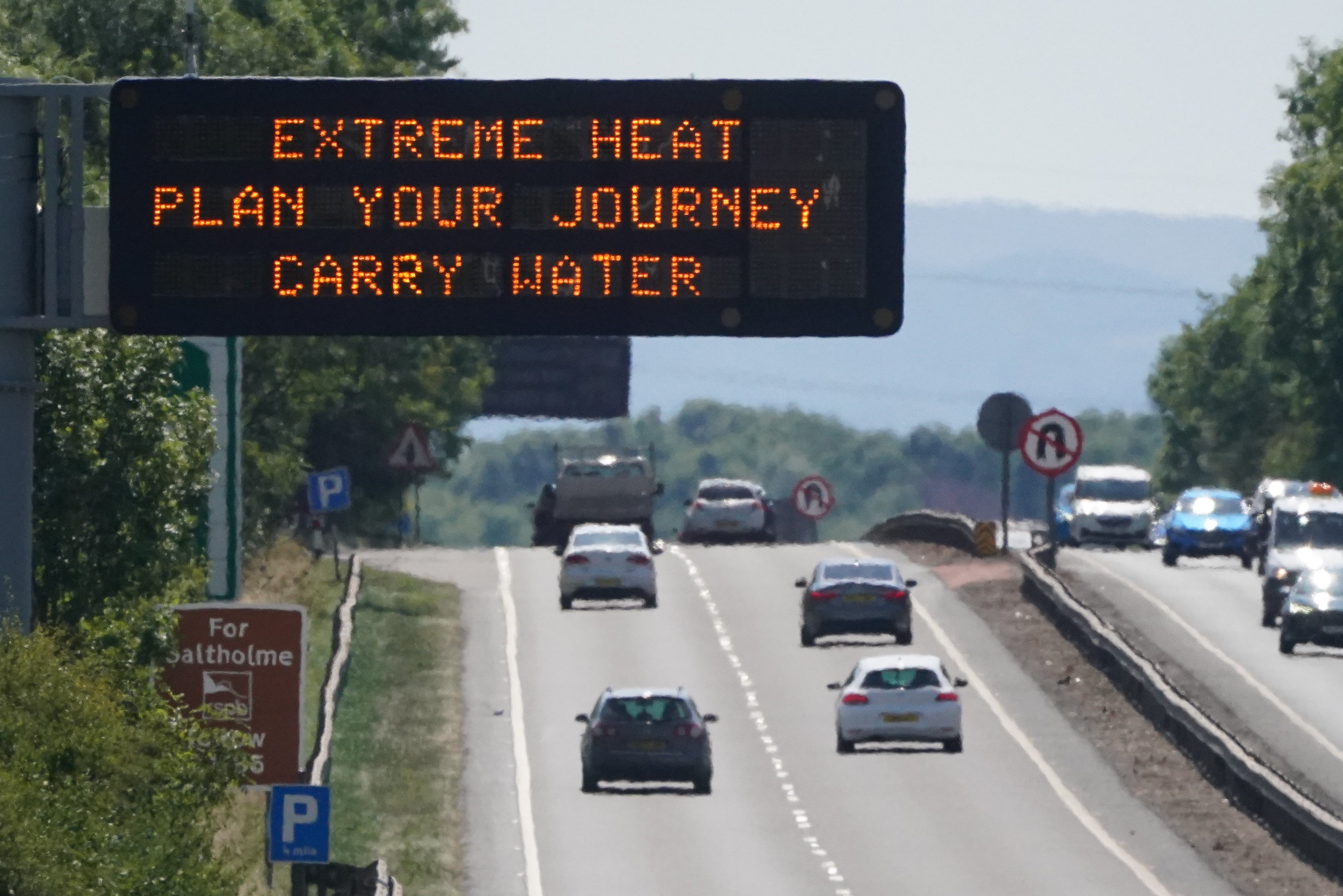 A sign over the A19 road towards Teesside warns over extreme weather as the UK braces for the upcoming heatwave (Owen Humphreys/PA)