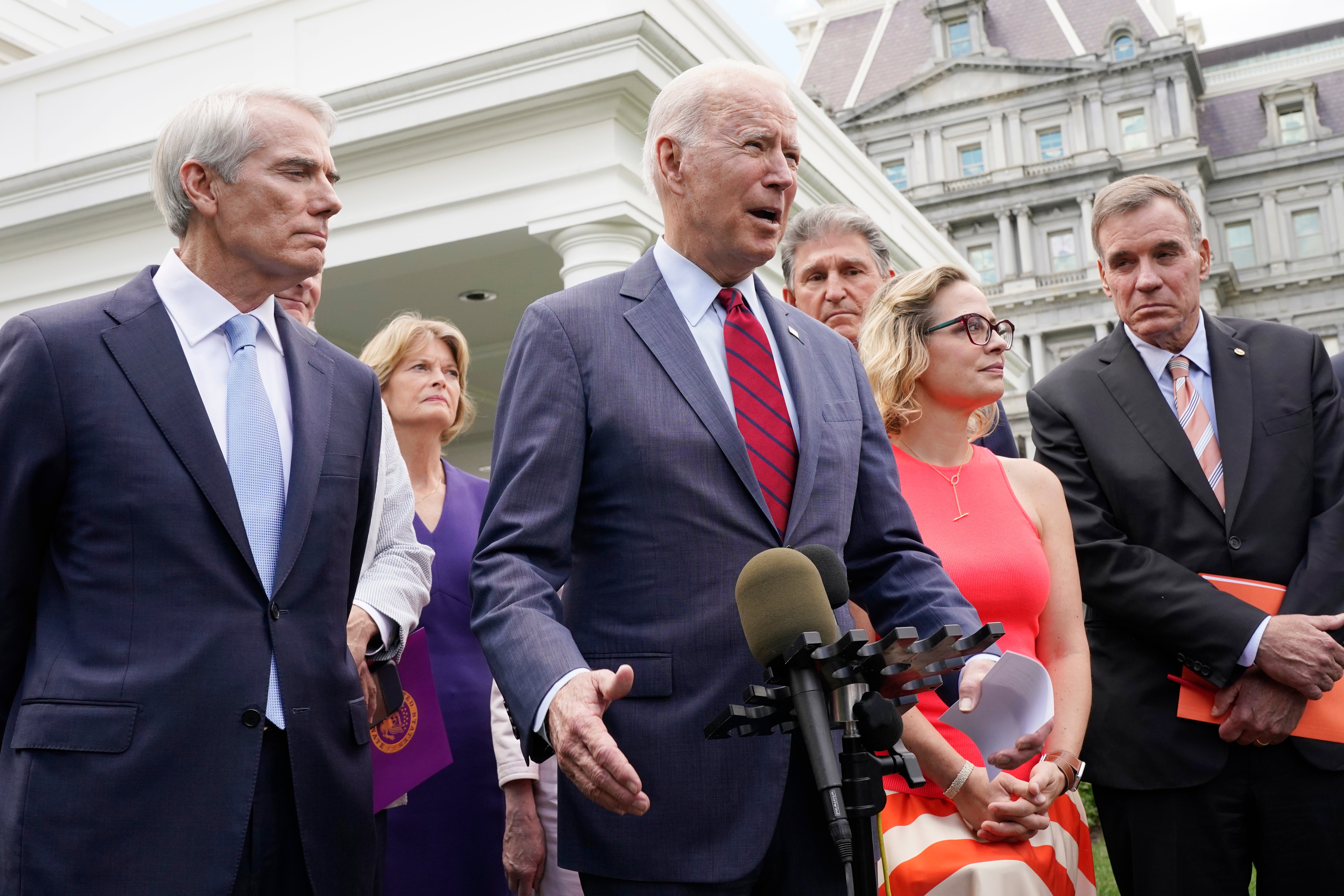 Biden with a bipartisan group of Senators including Rob Portman and Tammy Baldwin