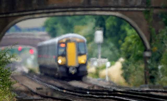 A train passes through heat haze on a railway line near Ashford in Kent (Gareth Fuller/PA)