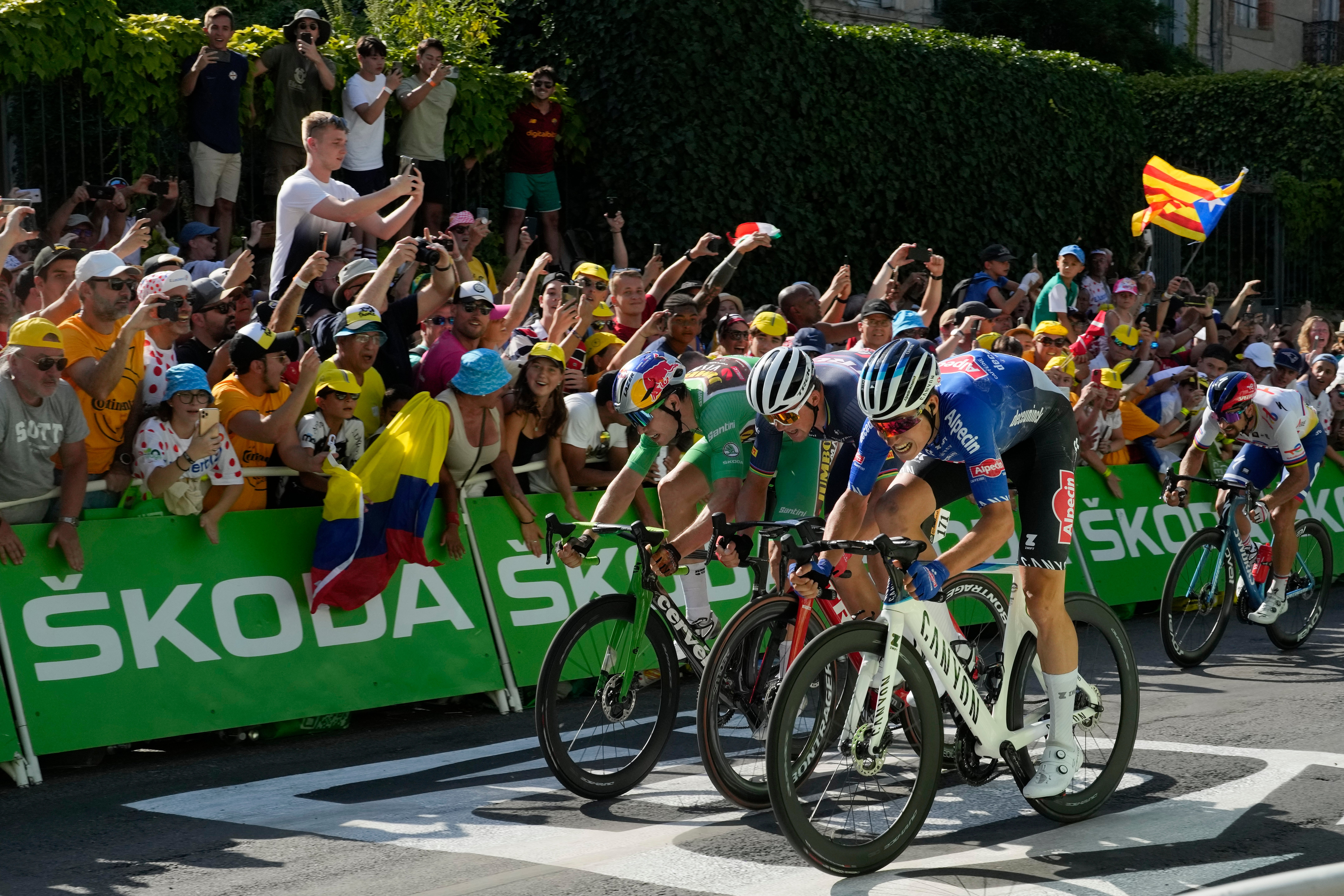 Belgium’s Jasper Philipsen, right, edges a sprint finish to win stage 15 of the Tour de France in Carcassonne (Thibault Camus/AP)