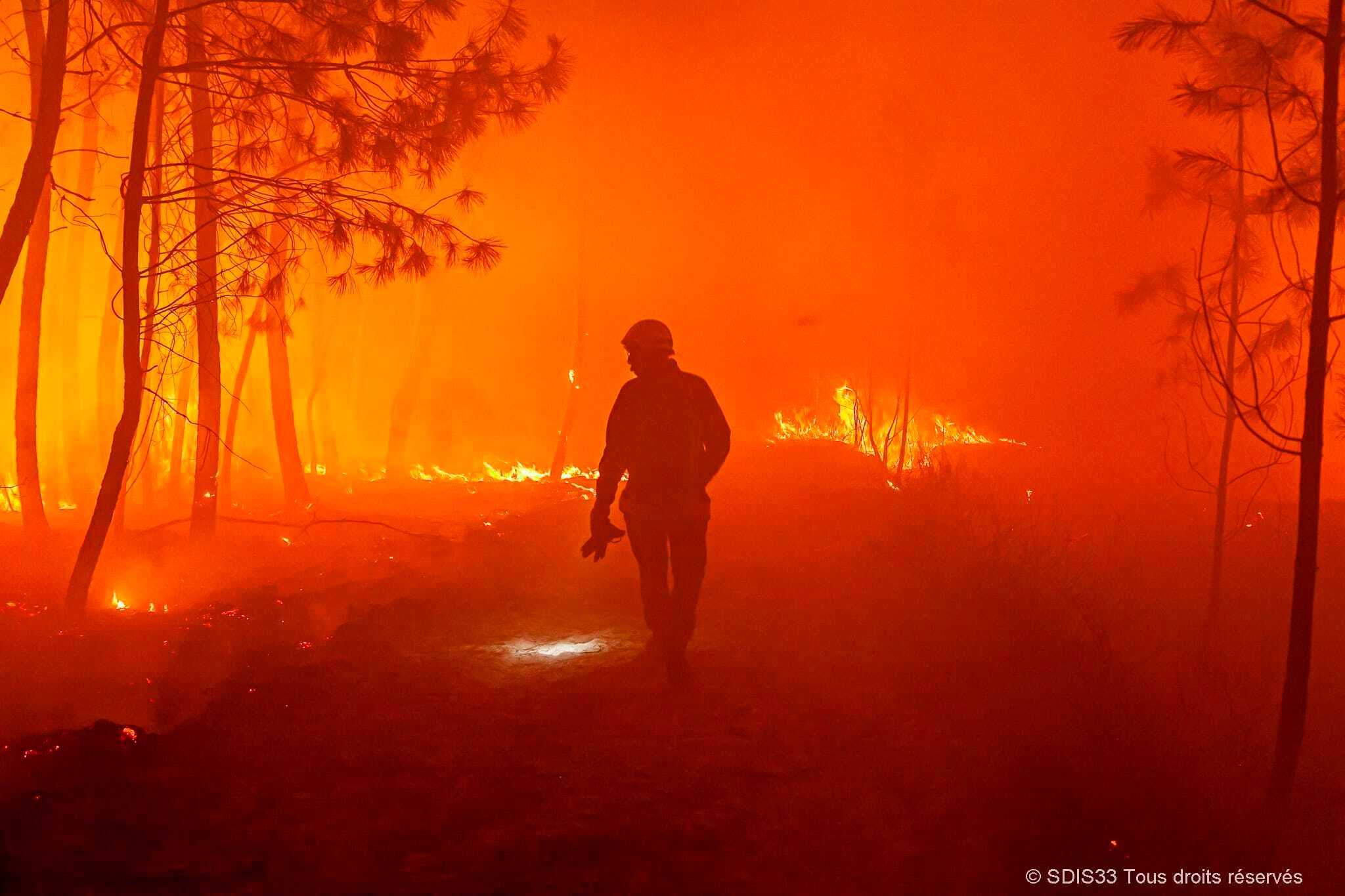 Firefighters fighting a forest fire near Landiras