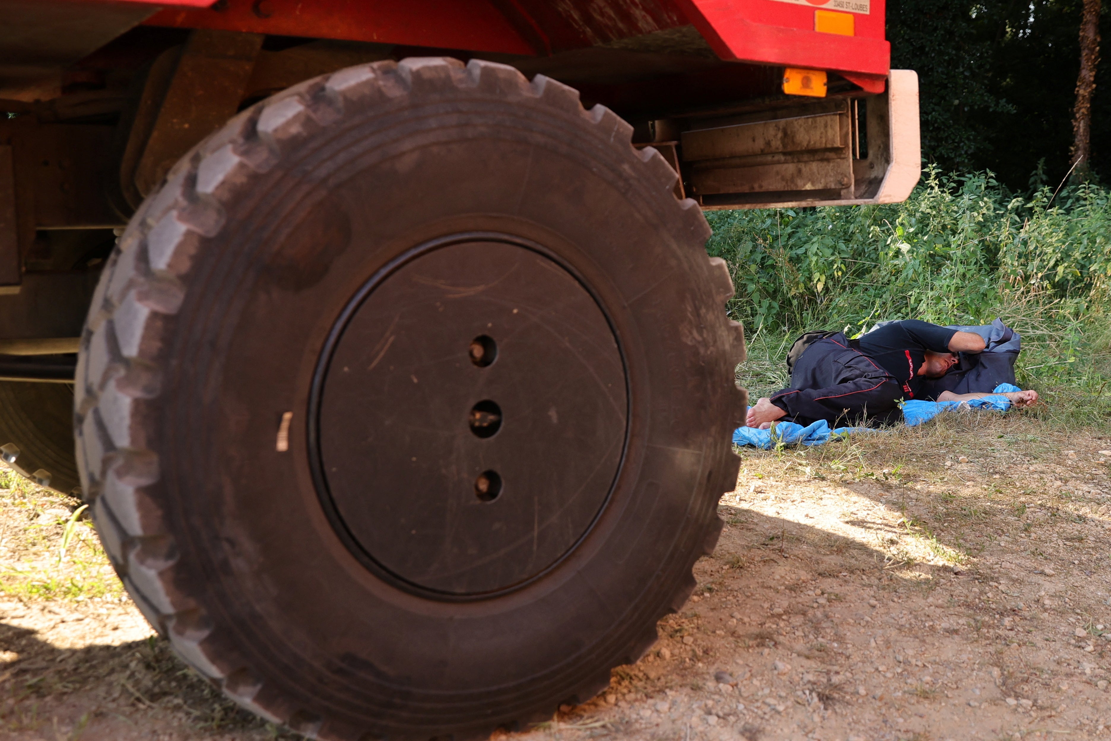 A firefighter rests after working near Landiras, as wildfires continue to spread in the Gironde region of southwestern France