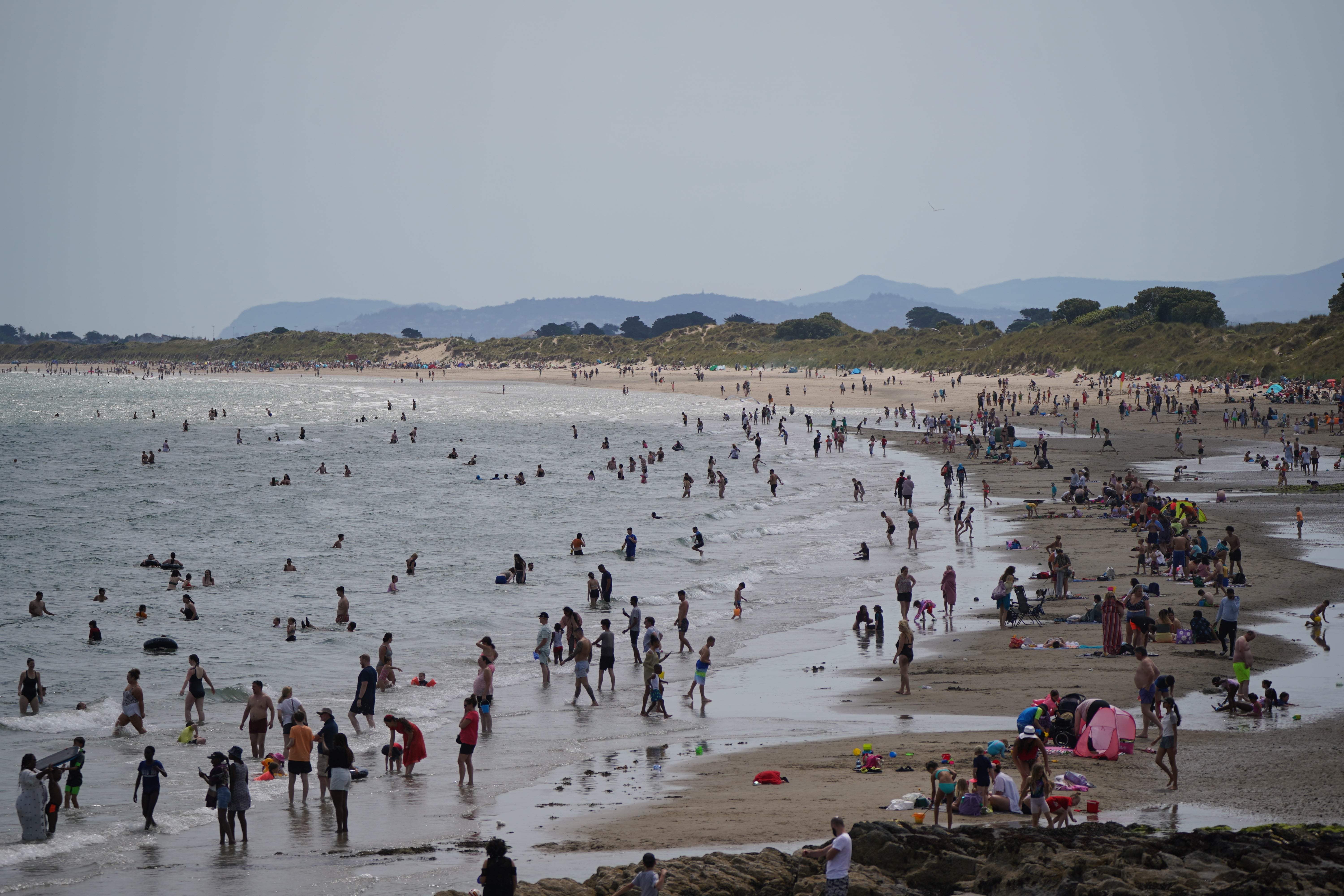 Crowds of people enjoying the sun on Portmarnock beach near Dublin (PA)