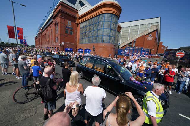 Crowds watched the funeral cortege pass Ibrox stadium (Andrew Milligan/PA)