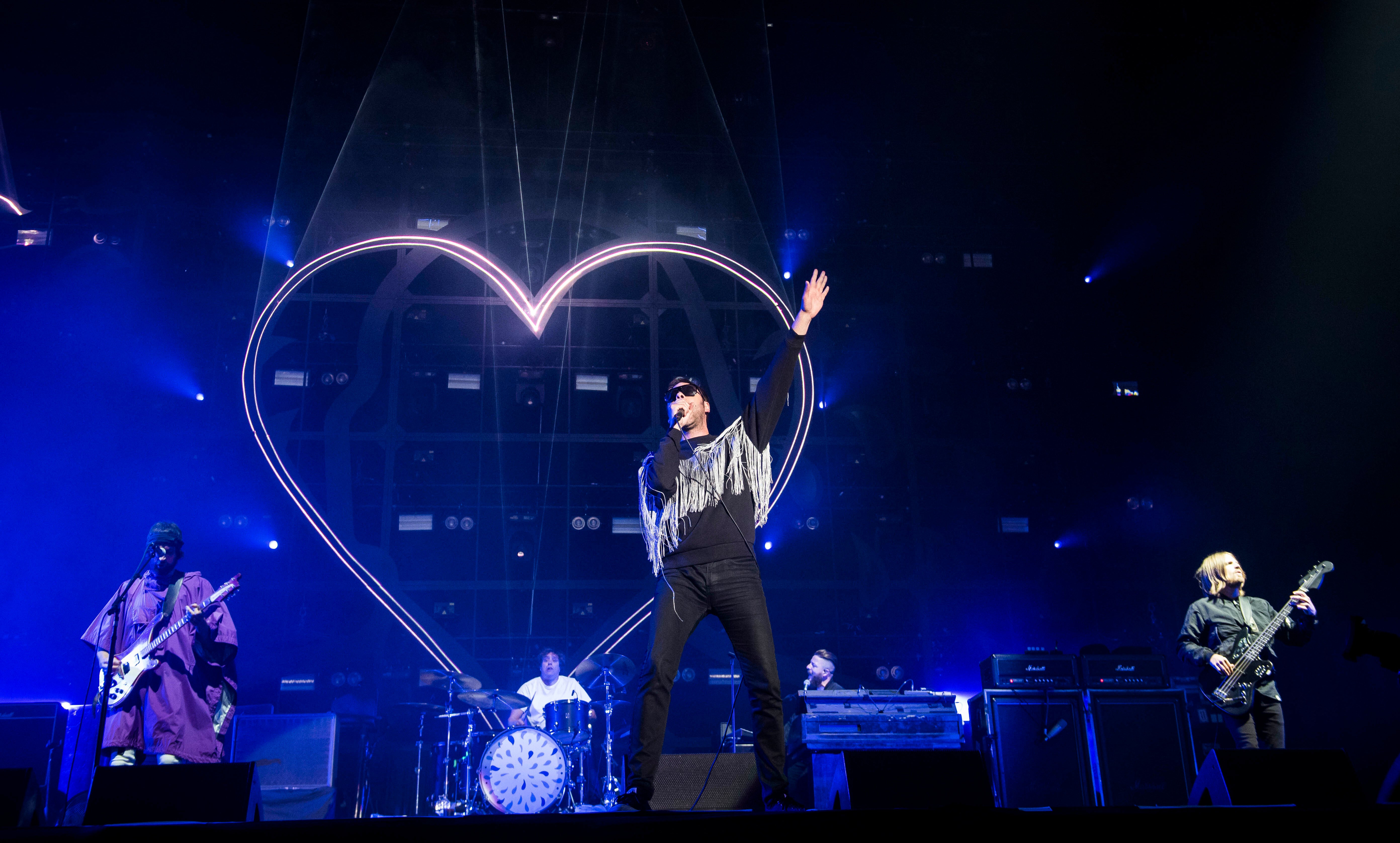 Kasabian performing on stage during the Isle of Wight Festival (PA)