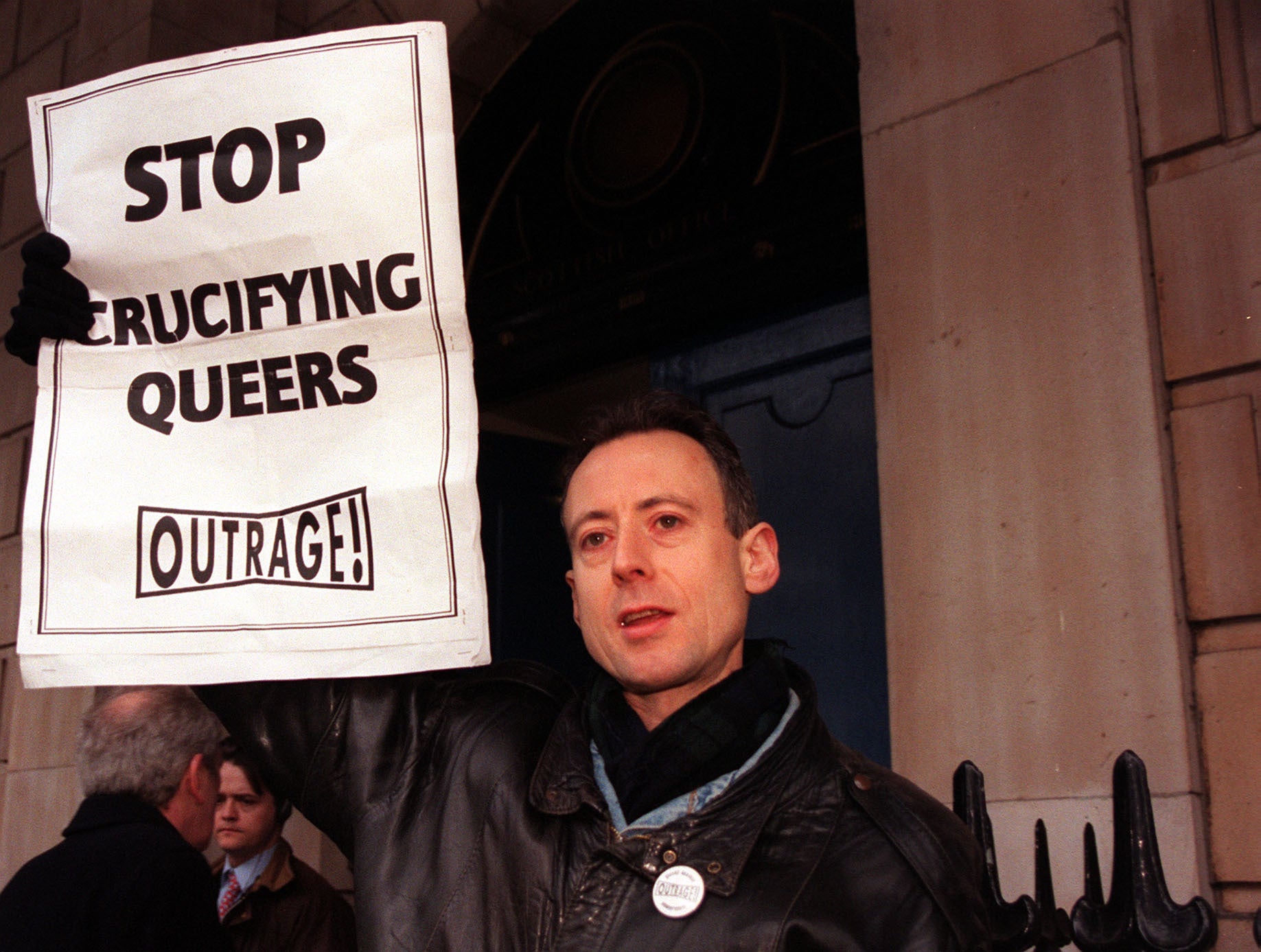Gay rights activist Peter Tatchell campaigns outside the Scotland Office at Dover House in London during the debate over repealing Section 28 (Tony Harris/PA)
