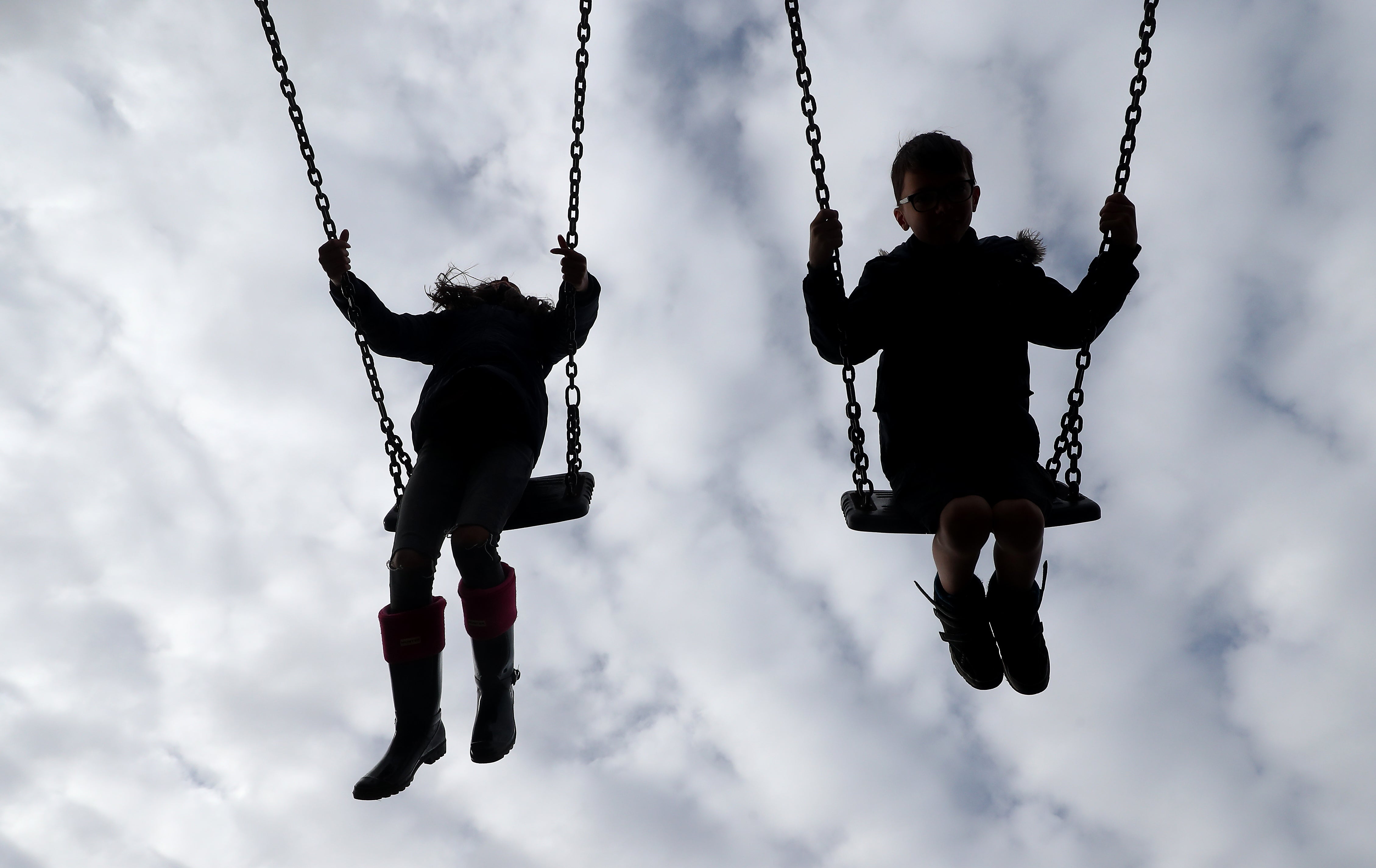 Children enjoy playing on swings (Gareth Fuller/PA)