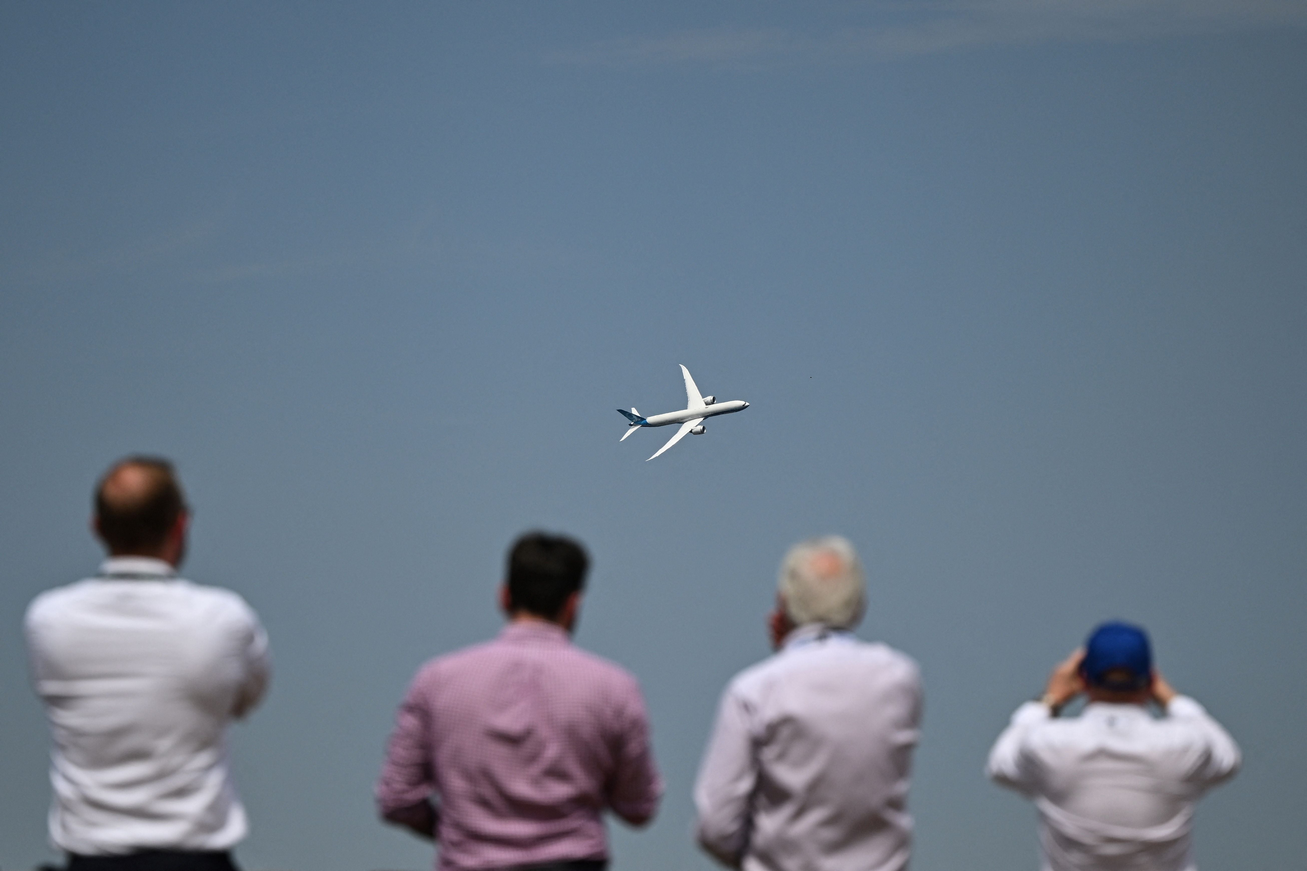 People watch a Boeing aeroplane at Farnborough Air Show on Tuesday where the government launched its new aviation strategy