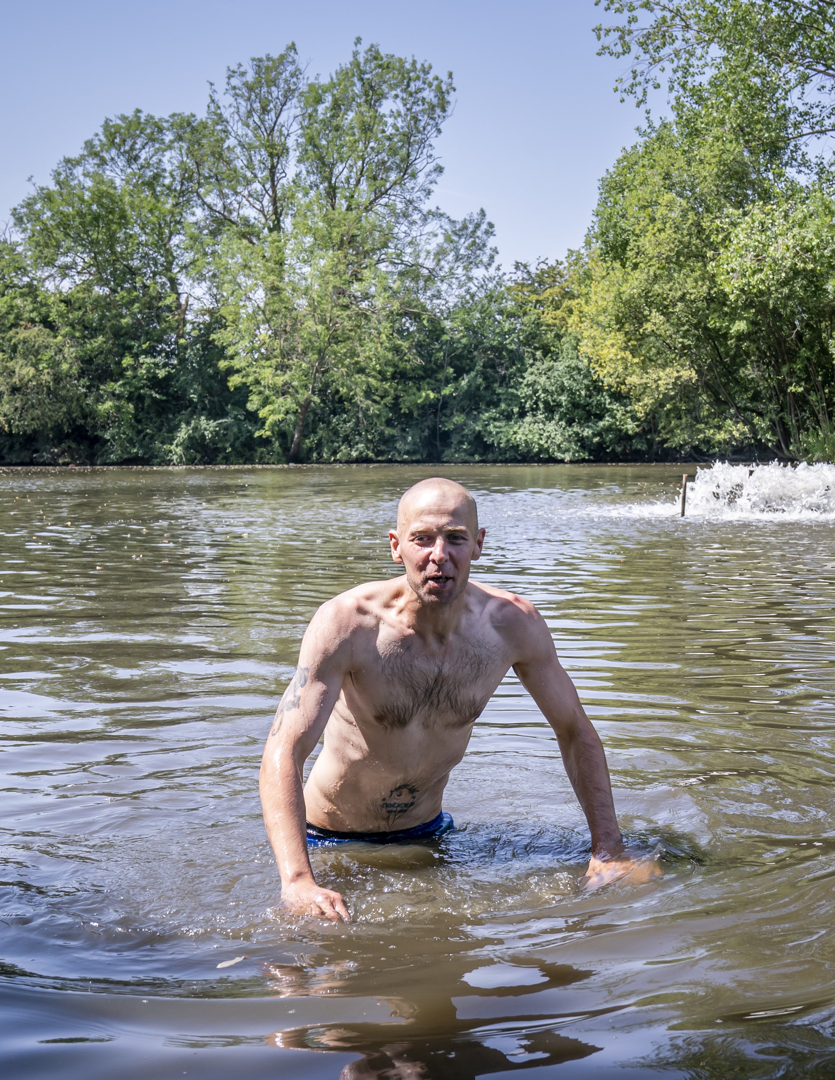 A man swims in a lake in Sandall Park, Doncaster (Danny Lawson/PA)