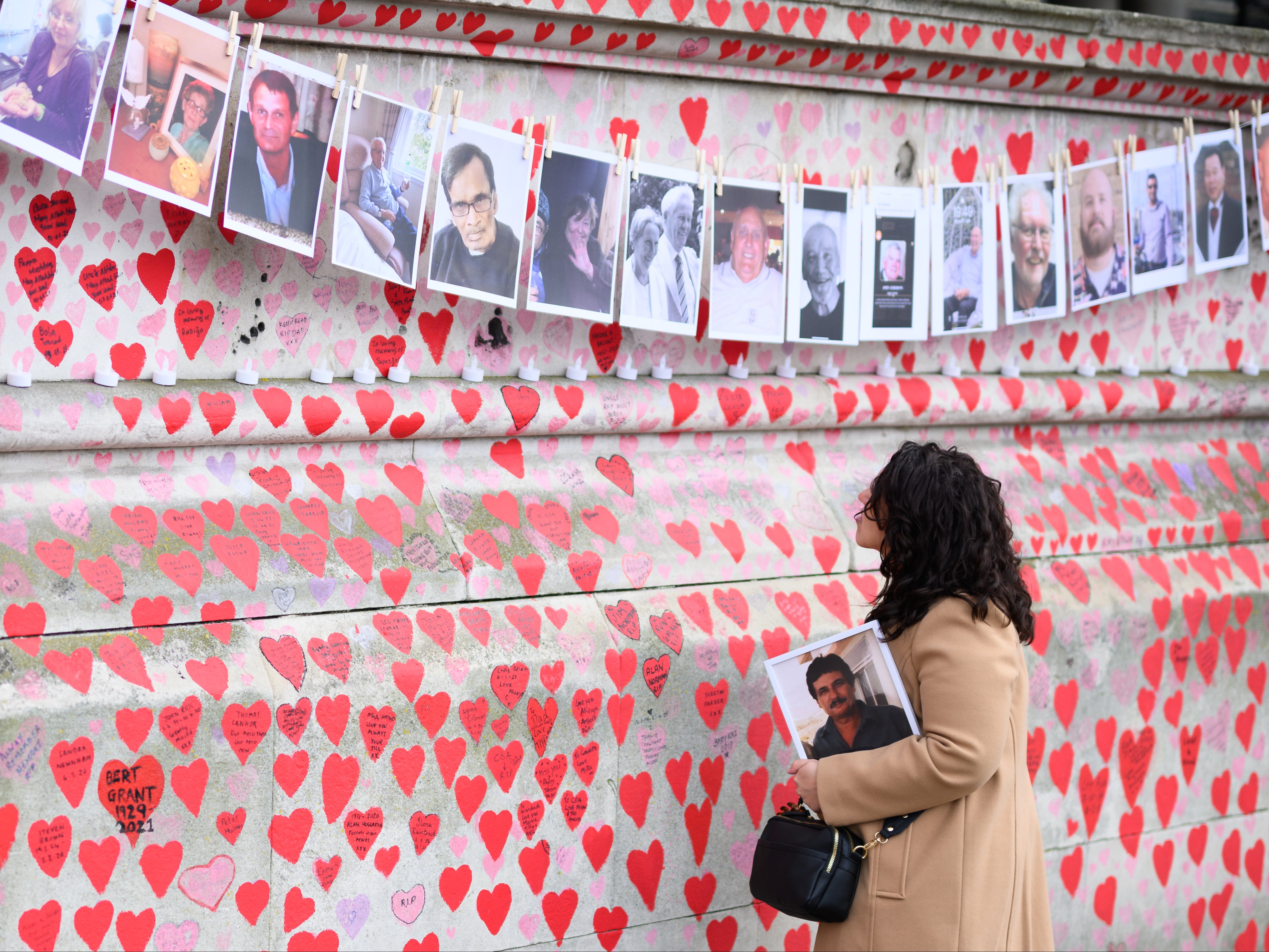 A woman looks at the Covid memorial wall in London, March