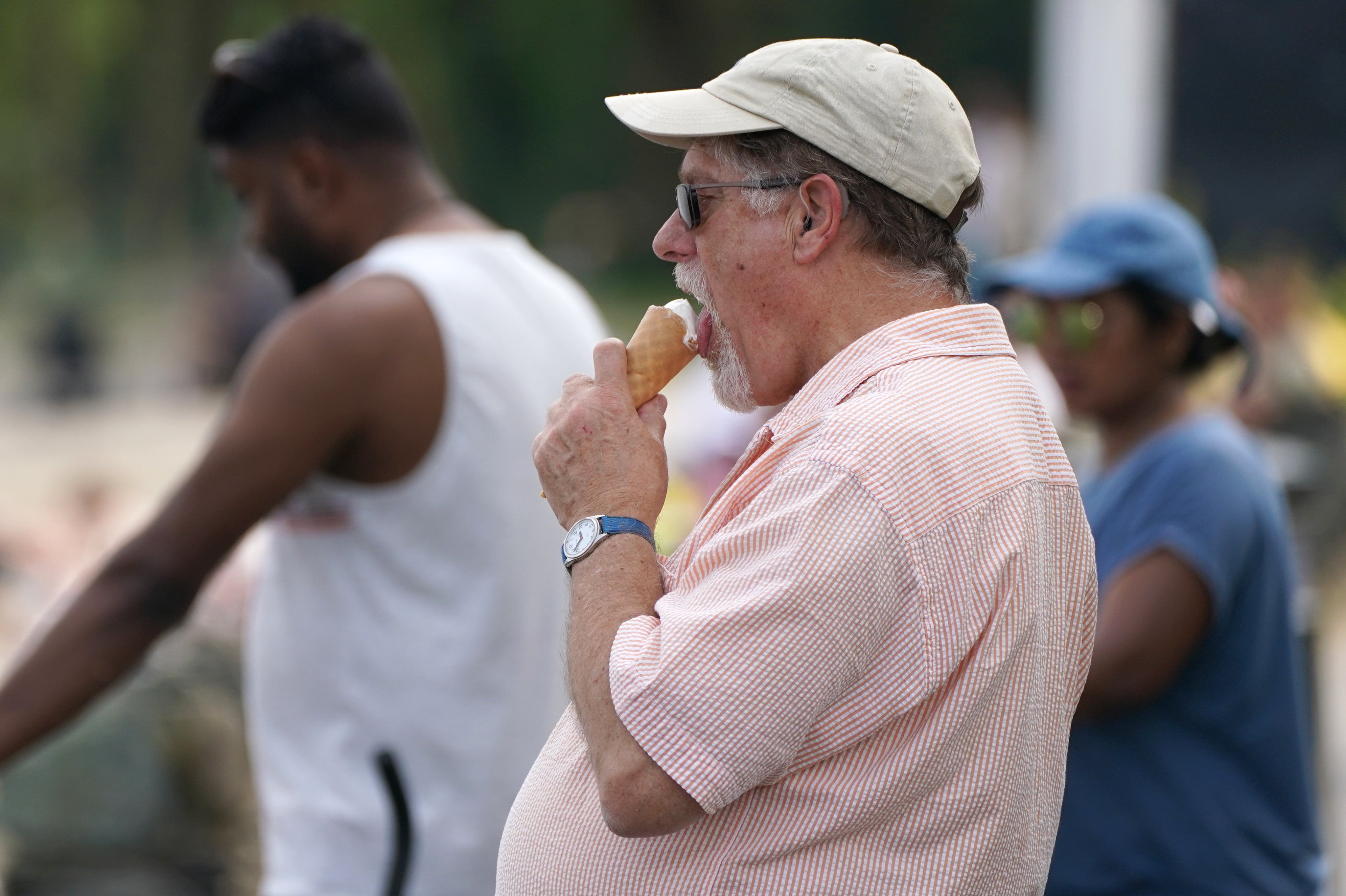 A man eating ice cream at Loch Lomond, in the village of Luss in Argyll and Bute (Andrew Milligan/PA)