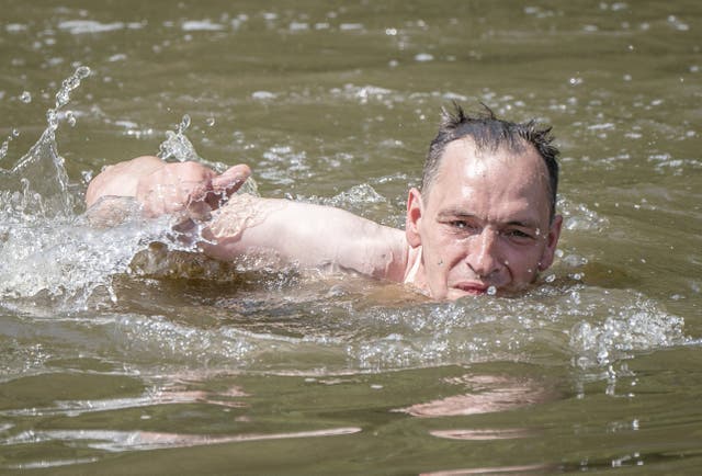 A man swims in a lake in Sandall Park, Doncaster (Danny Lawson/PA)