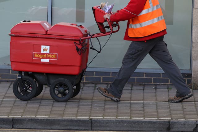 Royal Mail has posted a slump in sales and warned that disputes with workers are holding up turnaround plans (Steve Parsons/PA)