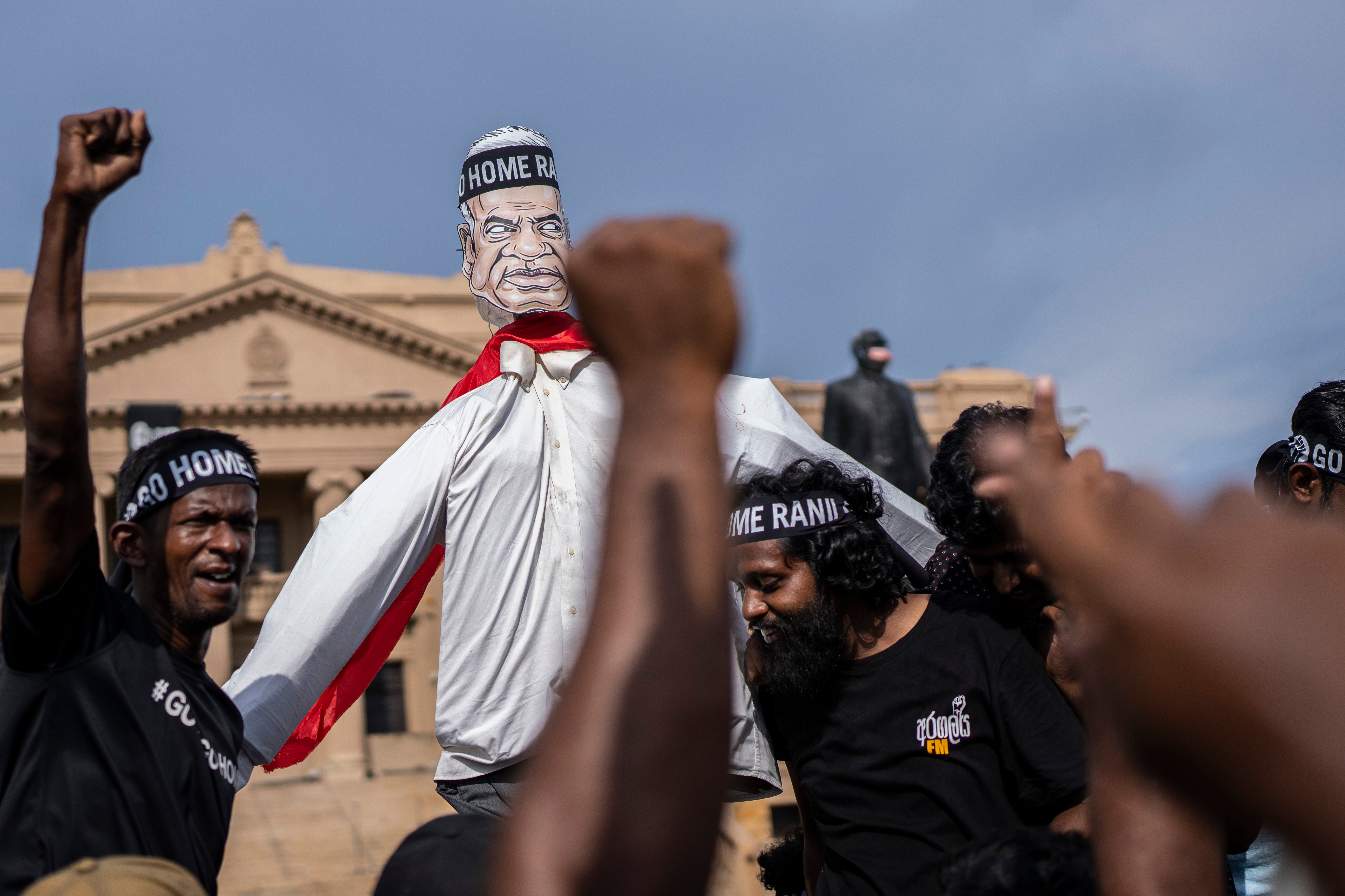 Protesters shout slogans demanding acting president and prime minister Ranil Wickremesinghe resign in Colombo, Sri Lanka, in Colombo a day before the vote