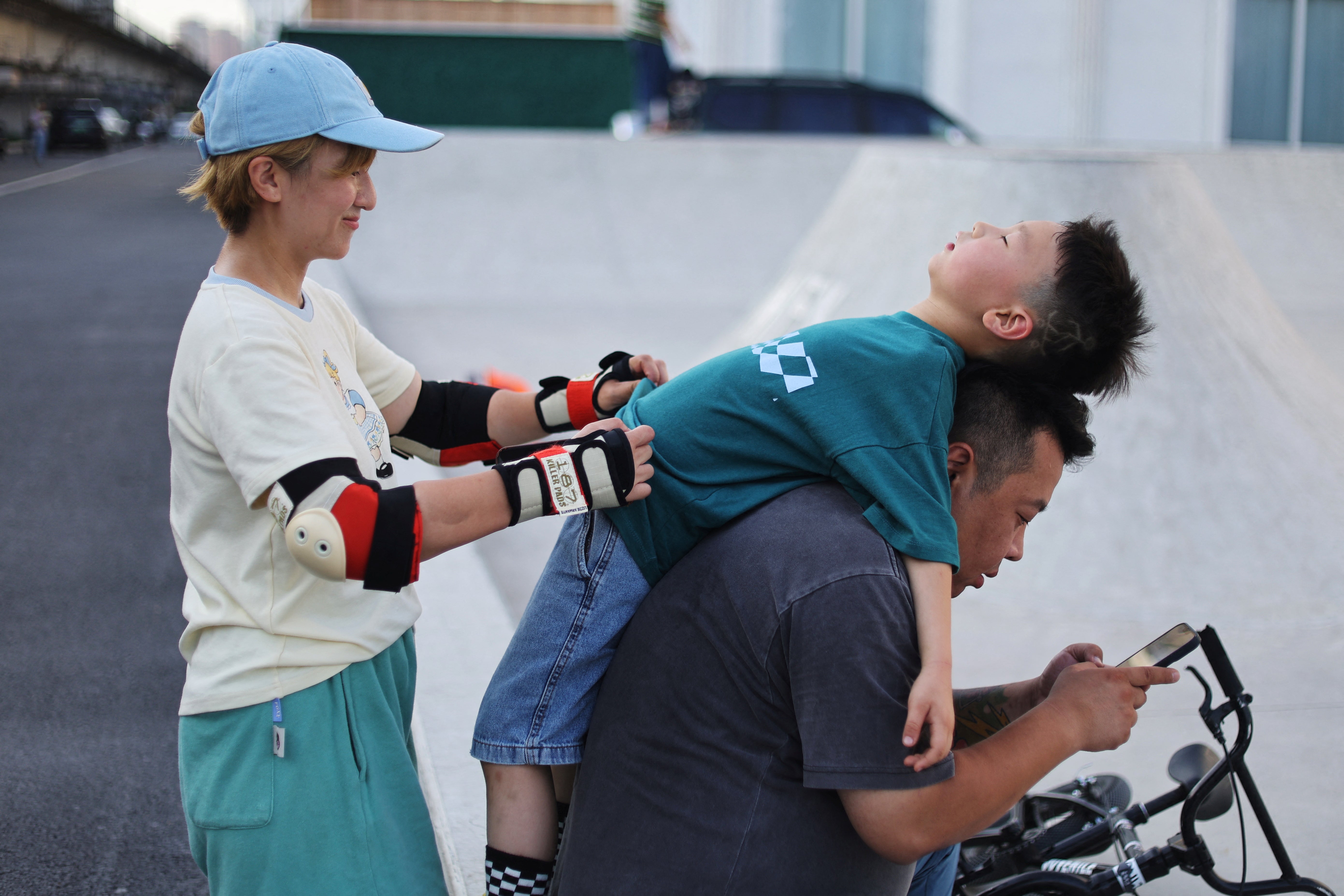 Mina Zhao with her son Leng Buding and husband Leng Ning, as she practises surfskating in Beijing