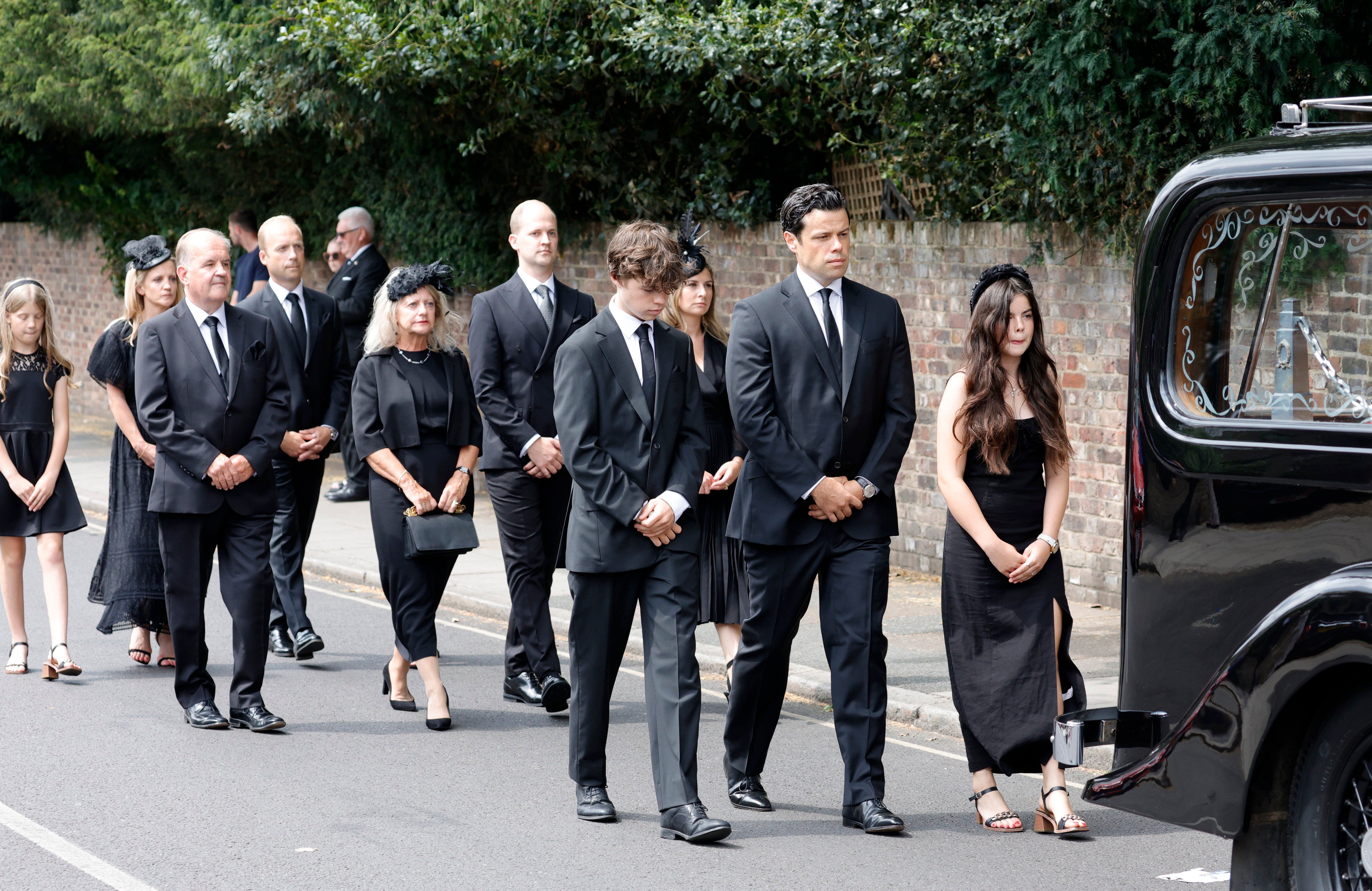 Hugo Bowen, Sebastien Bowen and Eloise Bowen lead the procession with (L-R second row) parents Alistair James, Heather James and brother Ben James during the funeral of Dame Deborah James at St Mary's Church