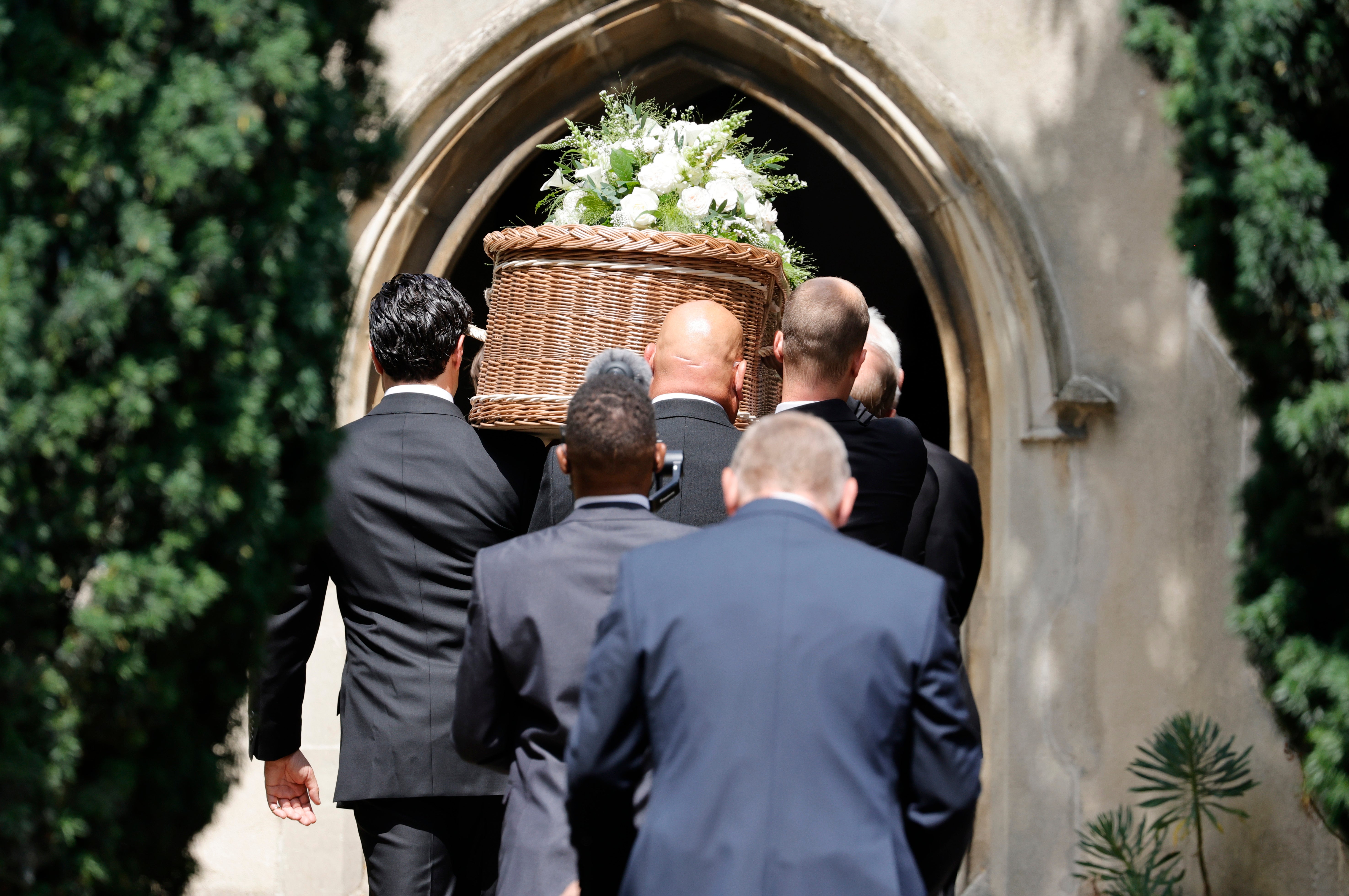 The coffin is carried into the church by pallbearers during the funeral of Dame Deborah James