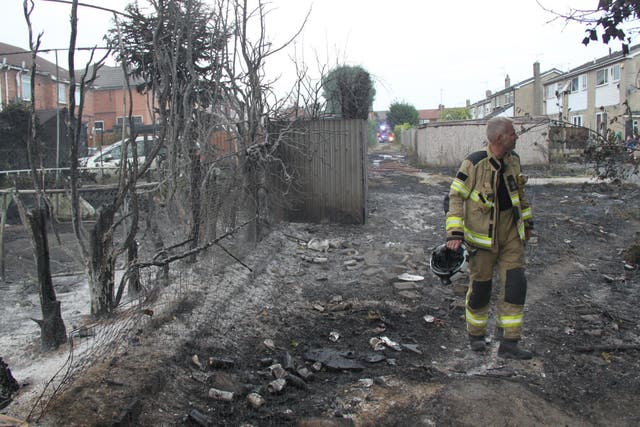 Firefighters in Maltby after a fire started on scrubland before spreading to outbuildings, fences and homes (South Yorkshire Fire Twitter/PA)