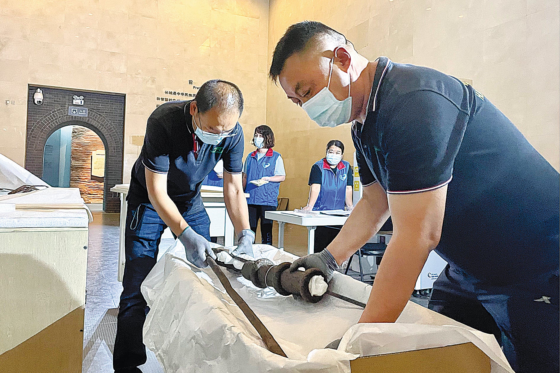 Staff of the China Great Wall Museum pack exhibits before the start of renovation work