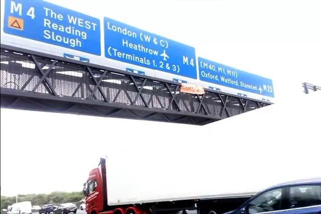 <p>Just Stop Oil activists climbed motorway signs on the M25 (handout/PA)</p>