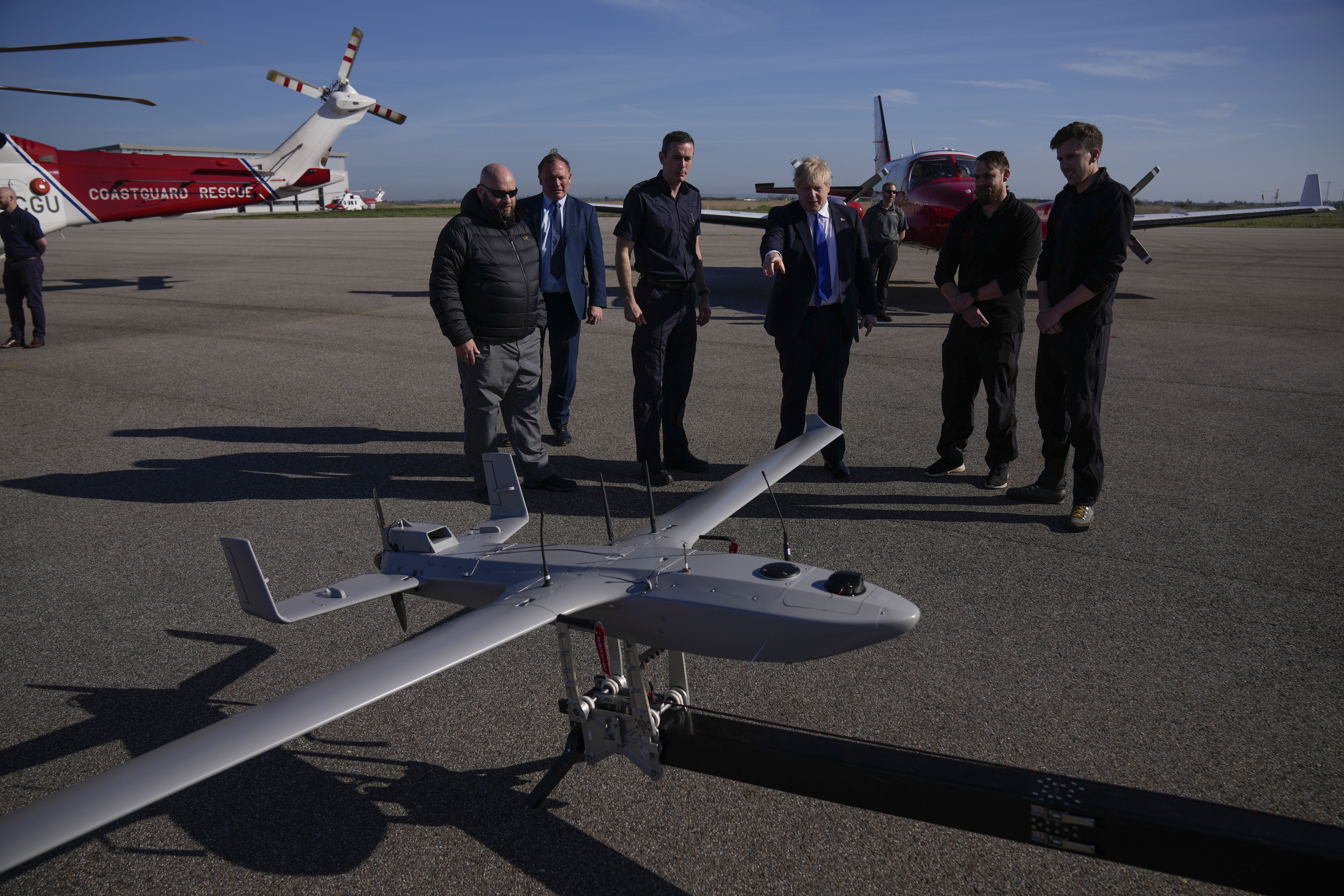Prime Minister Boris Johnson looks at a Coastguard drone for surveillance and rescue of migrants (PA)