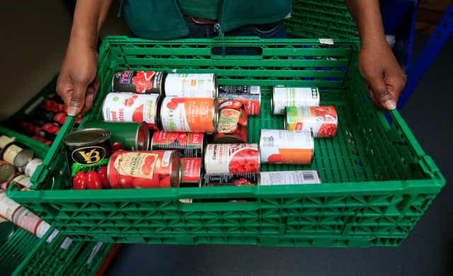 <p>Benefit deductions are forcing some families to use food banks, MPs say (Jonathan Brady/PA)</p>