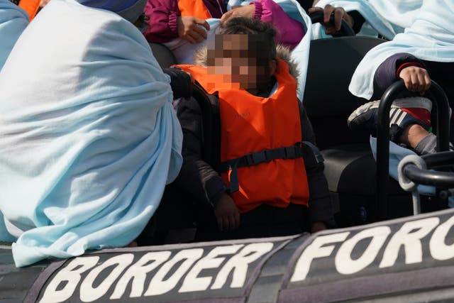 EDITORS NOTE: Children’s faces have been pixelated as the PA Picture Desk has been unable to gain the necessary permission to photograph a child under 16 on issues involving their welfare. A child amongst a group of people thought to be migrants are brought in to Dover, Kent, onboard a Border Force vessel following a small boat incident in the Channel. Picture date: Tuesday March 22, 2022. Photo credit should read: Gareth Fuller/PA Wire