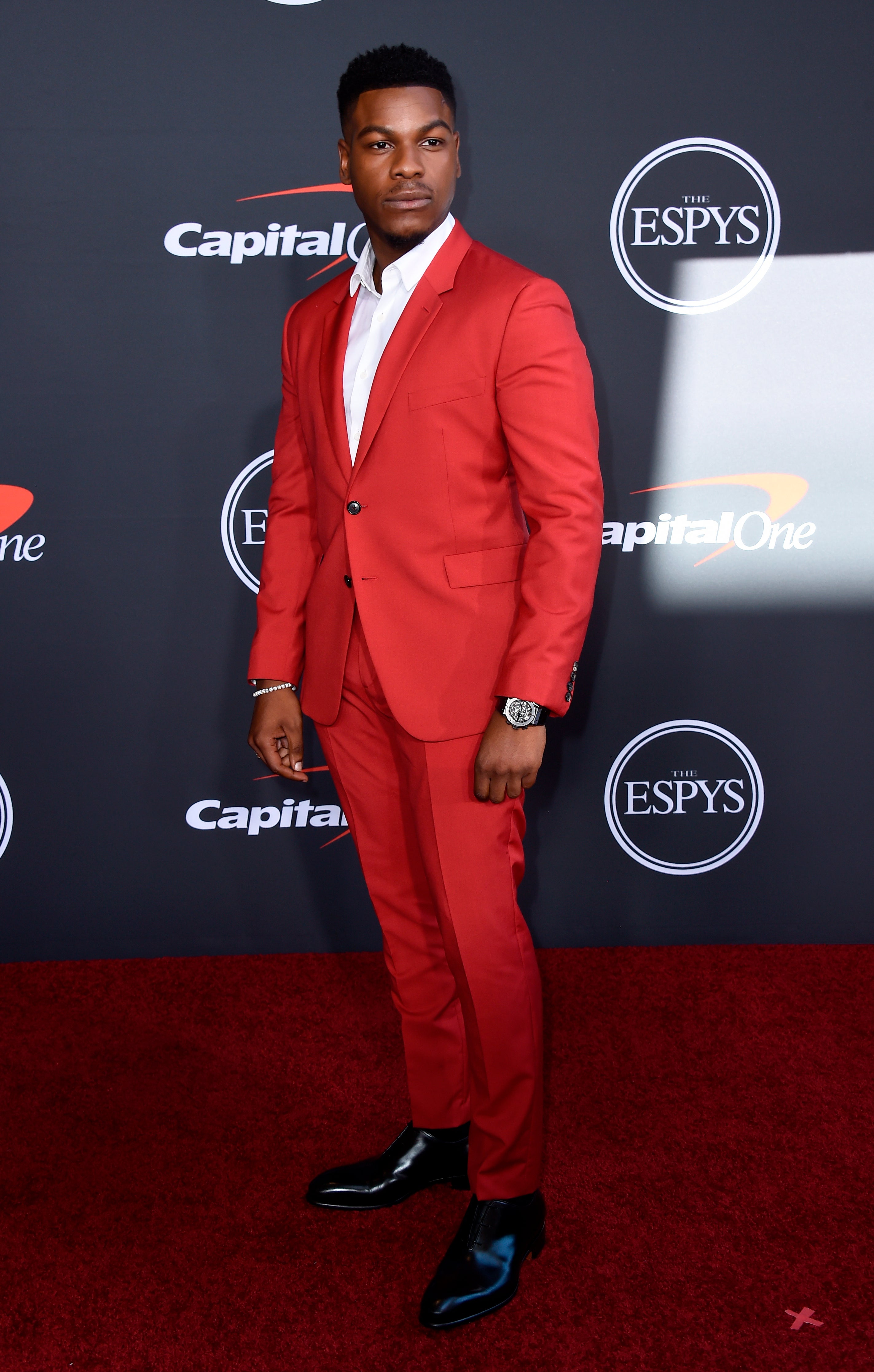 Boyega wore a blood red suit with an open white collar and later presented an award alongside rapper Lil Wayne (Jordan Strauss/AP)
