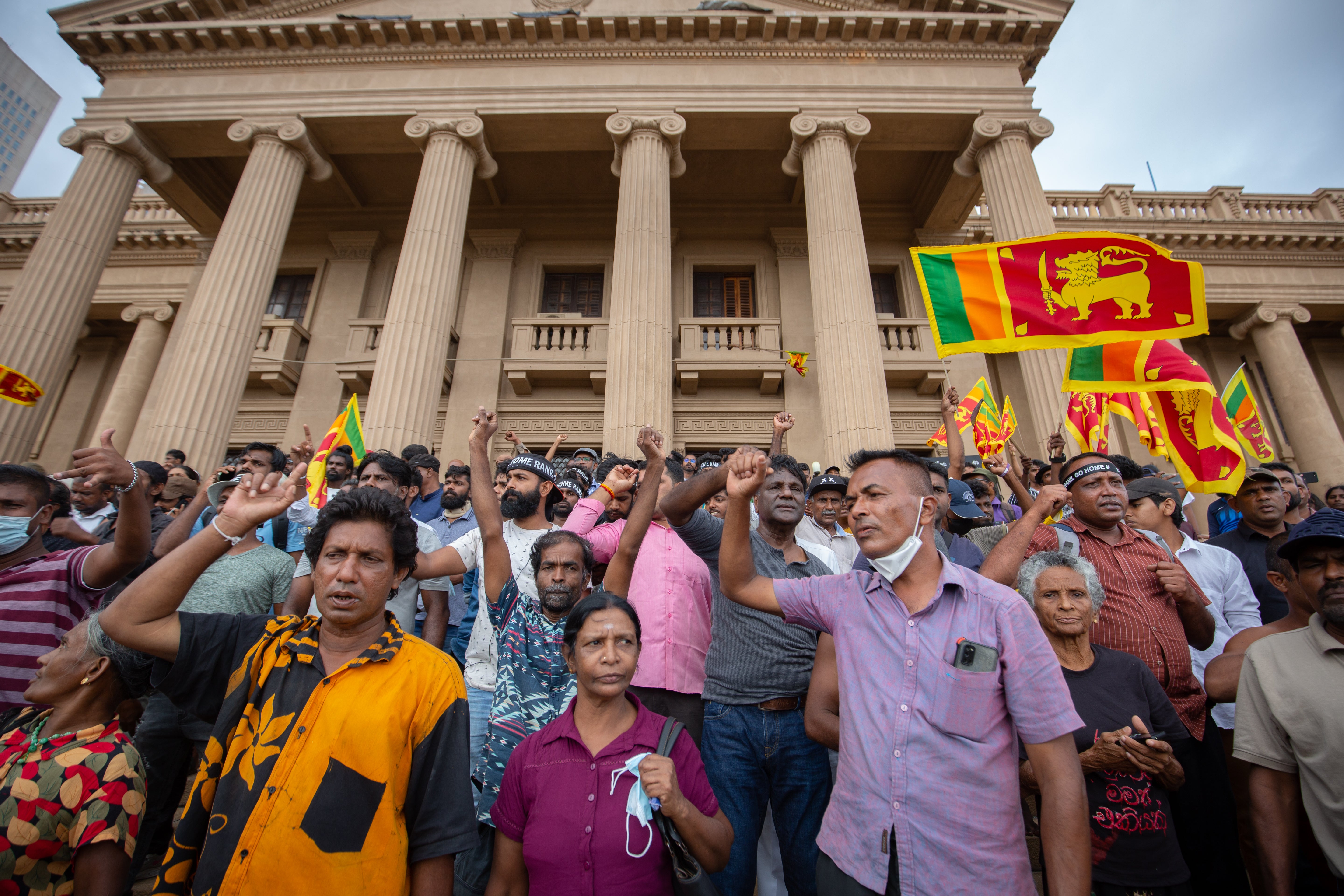 People react in protest to the announcement of President Wickremesinghe’s election in Colombo on Wednesday