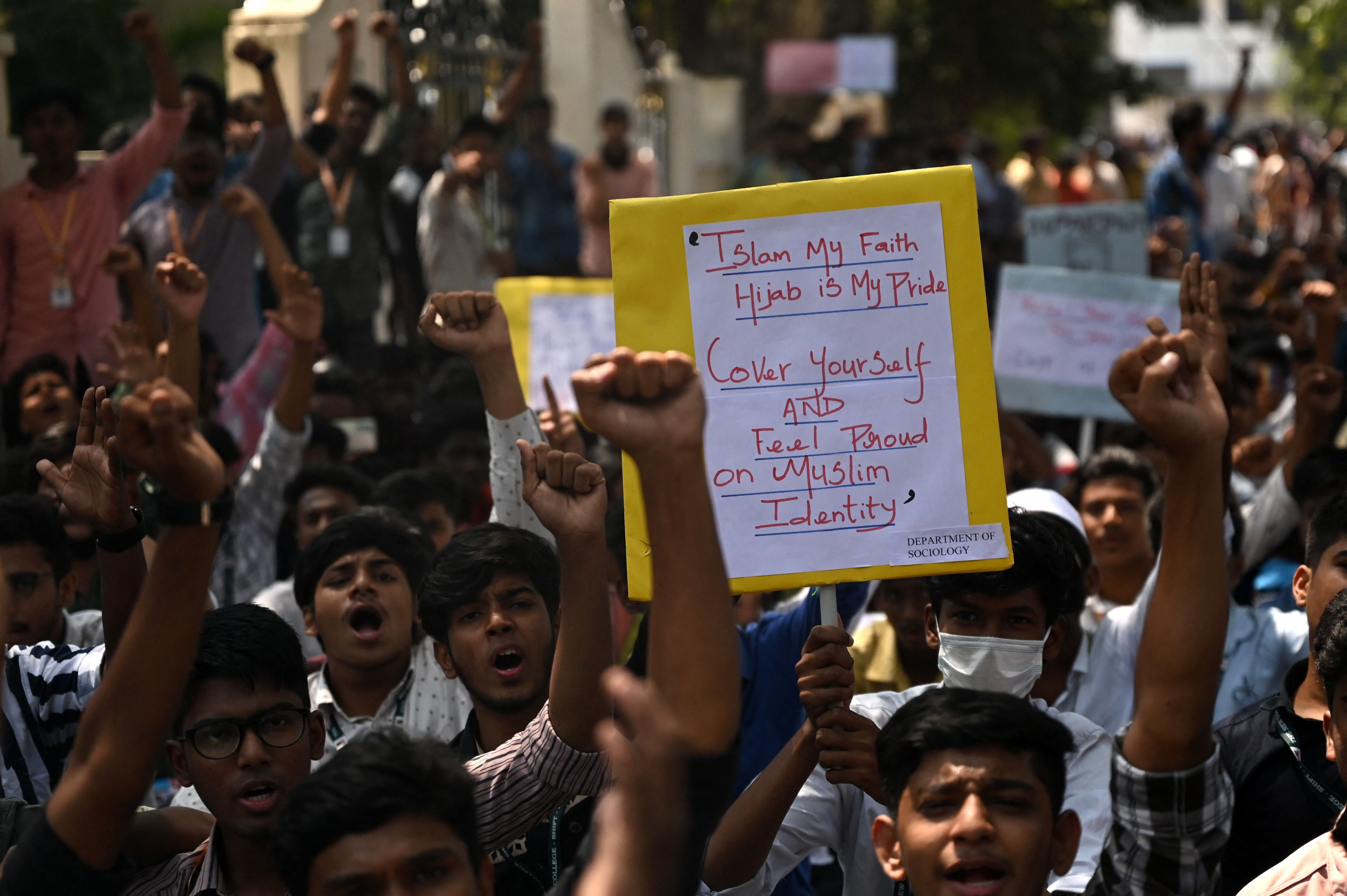 Students hold placards and shout slogans during a demonstration in Chennai against the decision of Karnataka’s High Court to uphold a local ban on the hijab being worn in classrooms