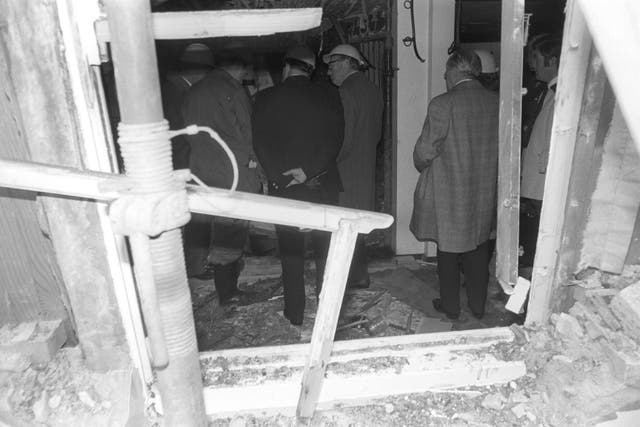 <p>The gutted shell of the Horse and Groom pub is inspected after the bombing </p>