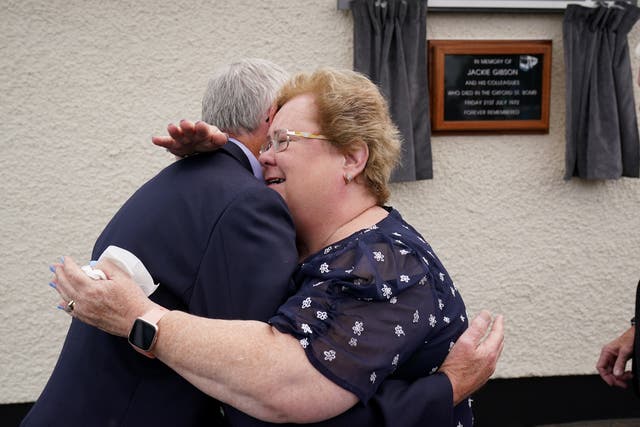 Daughter of bus driver Jackie Gibson Lynda Van Cuylenburg hugs her brother Robert Gibson, at an event with some of their father’s former colleagues in Ulsterbus and current drivers to unveil a plaque at the depot in Ballygowan where he began his journey on Bloody Friday. Jackie was killed in the bomb that detonated at the Oxford Street bus station on July 21 1972. Picture date: Thursday July 21, 2022.