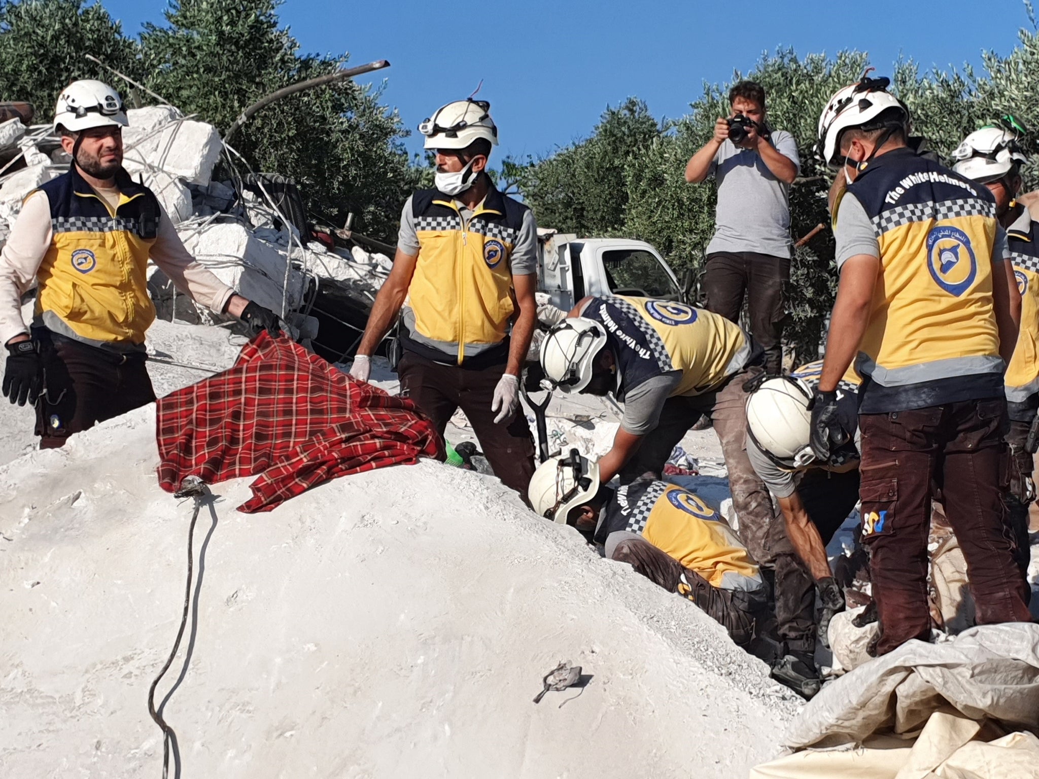 Civil defence group members and citizens carry out rescue works in the wreckage of the buildings destroyed after Russian attack