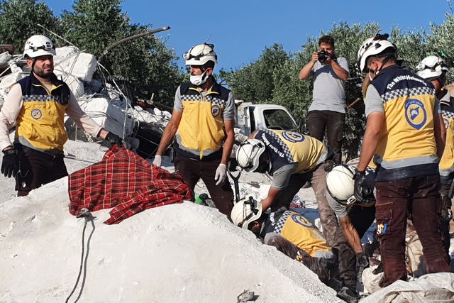 <p>Civil defence group members and citizens carry out rescue works in the wreckage of the buildings destroyed after Russian attack</p>