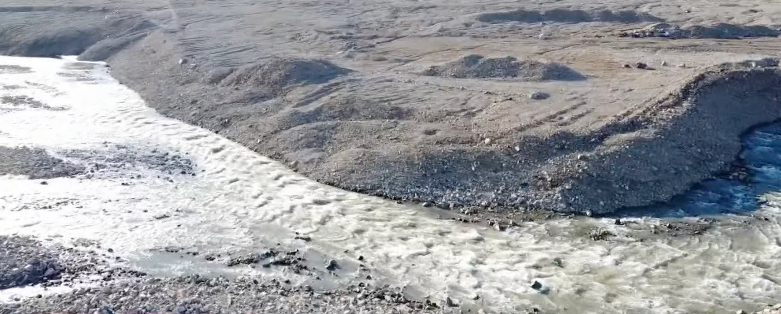 Water rushes over Greenland as the icy island experiences a heatwave