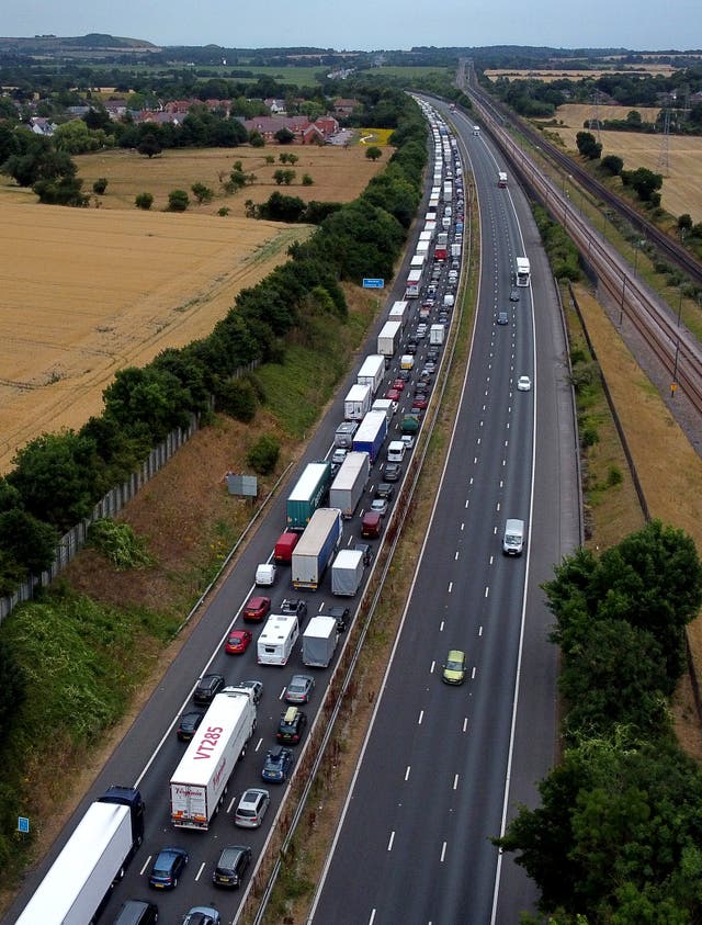Traffic heading for the Port of Dover and Eurotunnel queue on the M20 near Folkestone in Kent as families embark on getaways. (Gareth Fuller/PA)