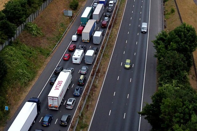 Traffic heading for the Port of Dover and Eurotunnel queue on the M20 near Folkestone in Kent as families embark on getaways. (Gareth Fuller/PA)