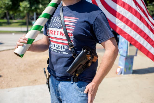 <p>An open-carrying Trump supporter </p>