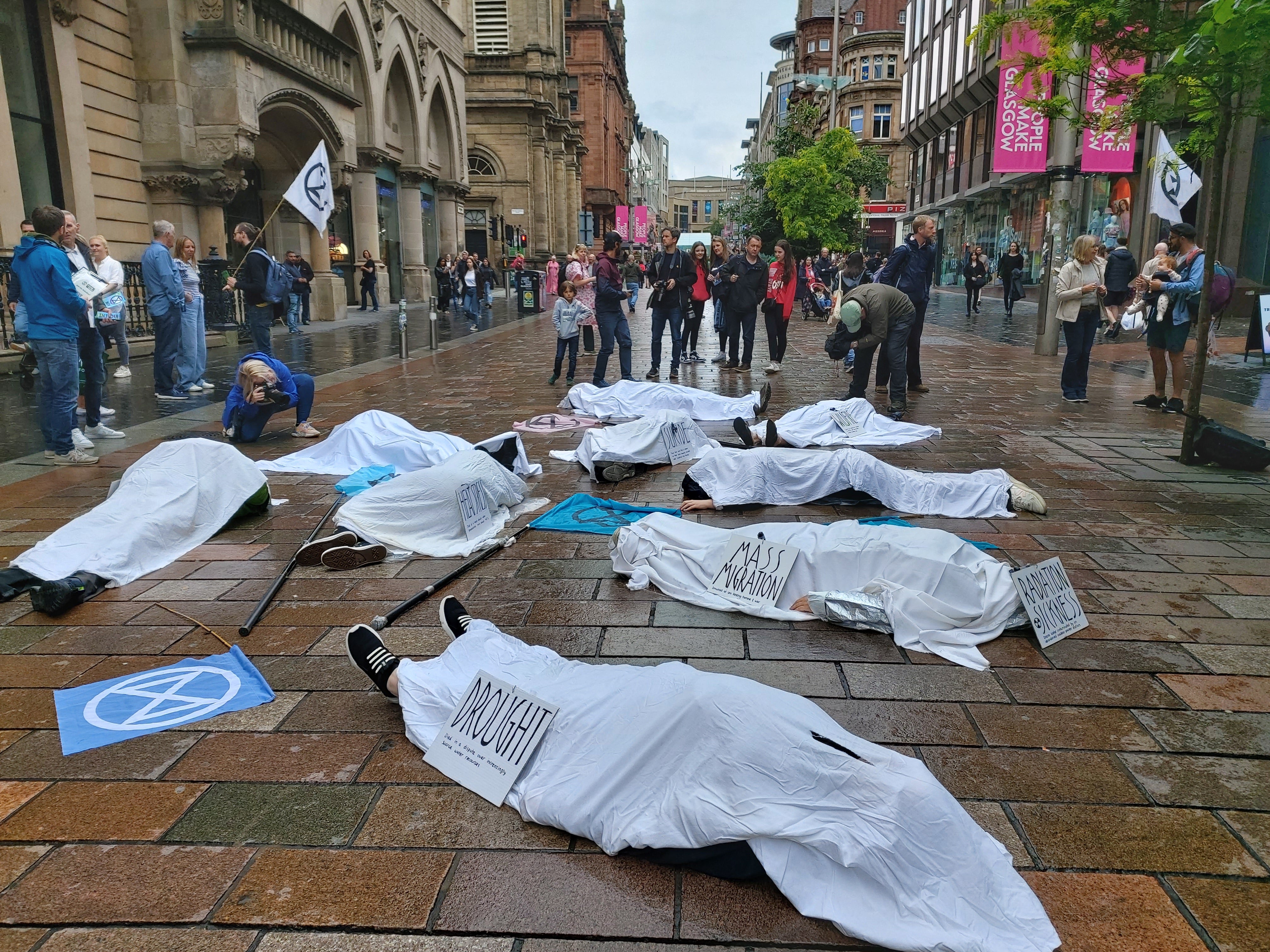 Climate activists stage die-in protest in Glasgow following record temperatures The Independent pic