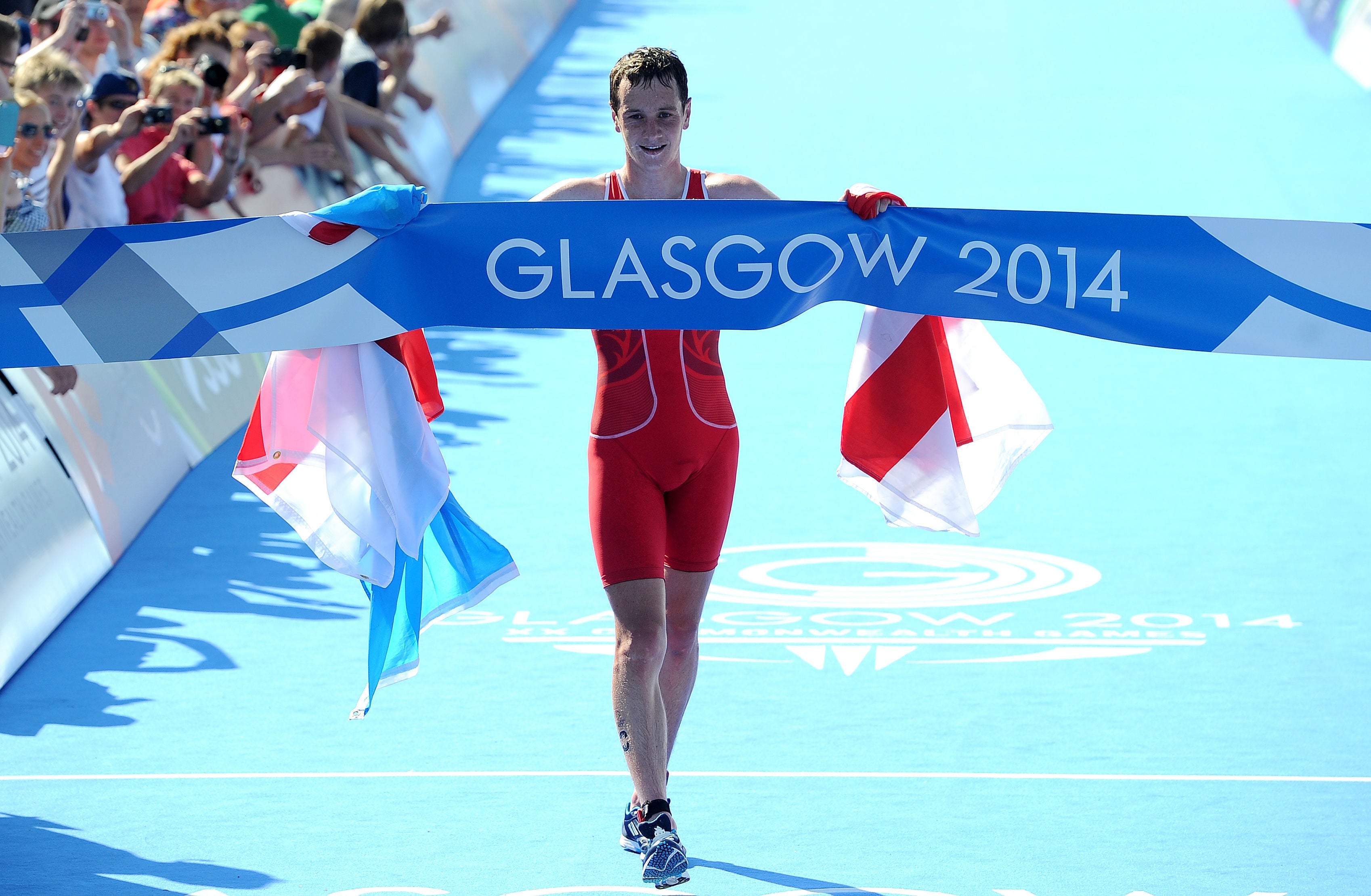 Alistair Brownlee celebrates as he crosses the line to win the men’s triathlon, at Strathclyde Country Park during the 2014 Commonwealth Games. (Martin Rickett/PA)