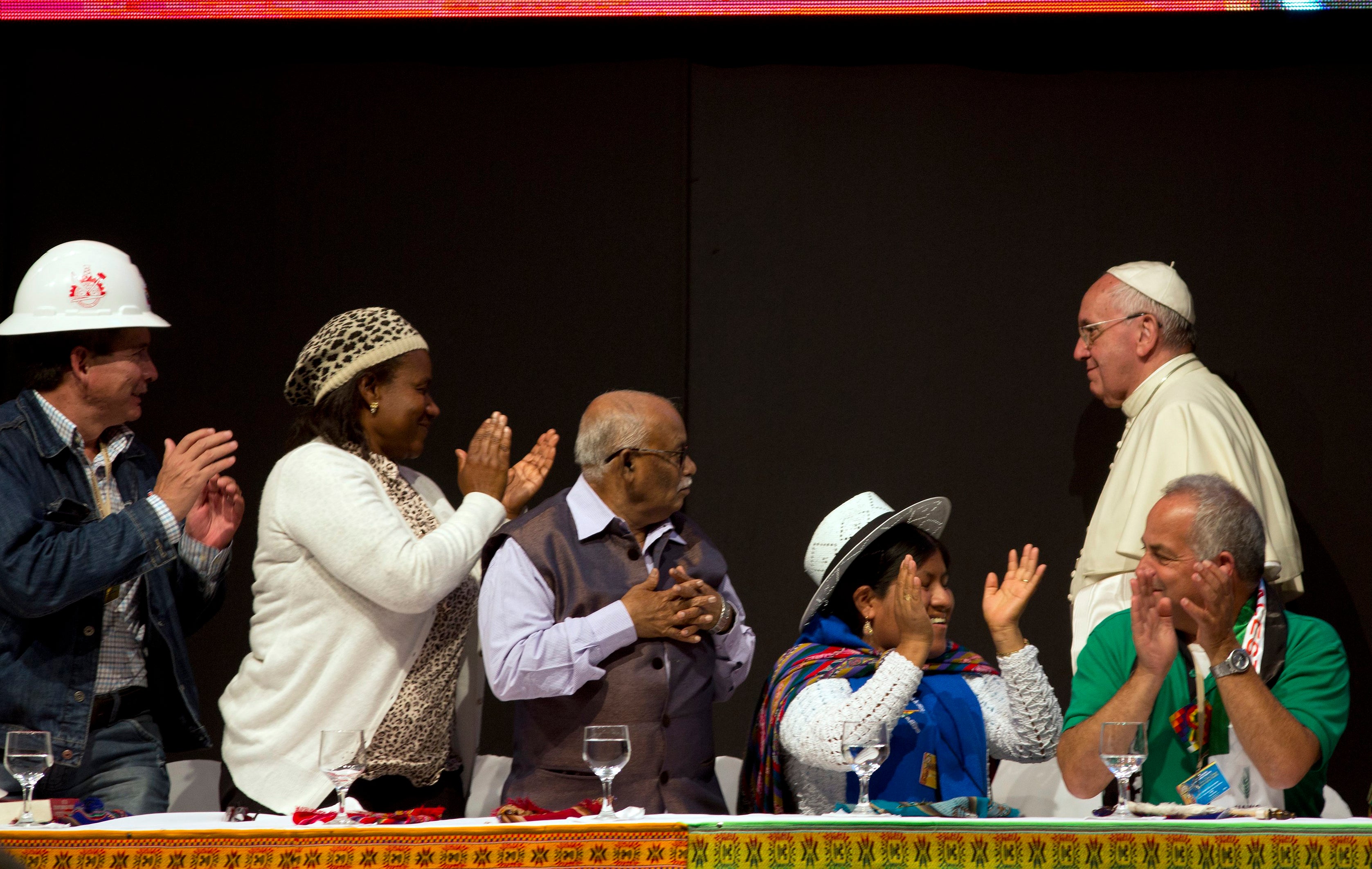 Delegates applaud Pope Francis, right, during the second World Meeting of Popular Movements in Santa Cruz, Bolivia, in July 2015. During his visit, Francis apologised for wrongs committed by the church against Indigenous peoples during the conquest of the Americas