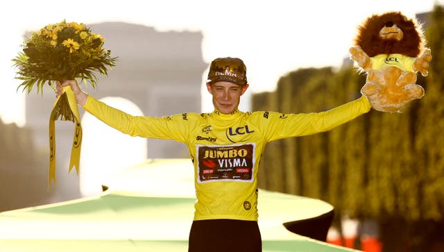 <p>Jumbo-Visma’s Jonas Vingegaard celebrates on the podium </p>